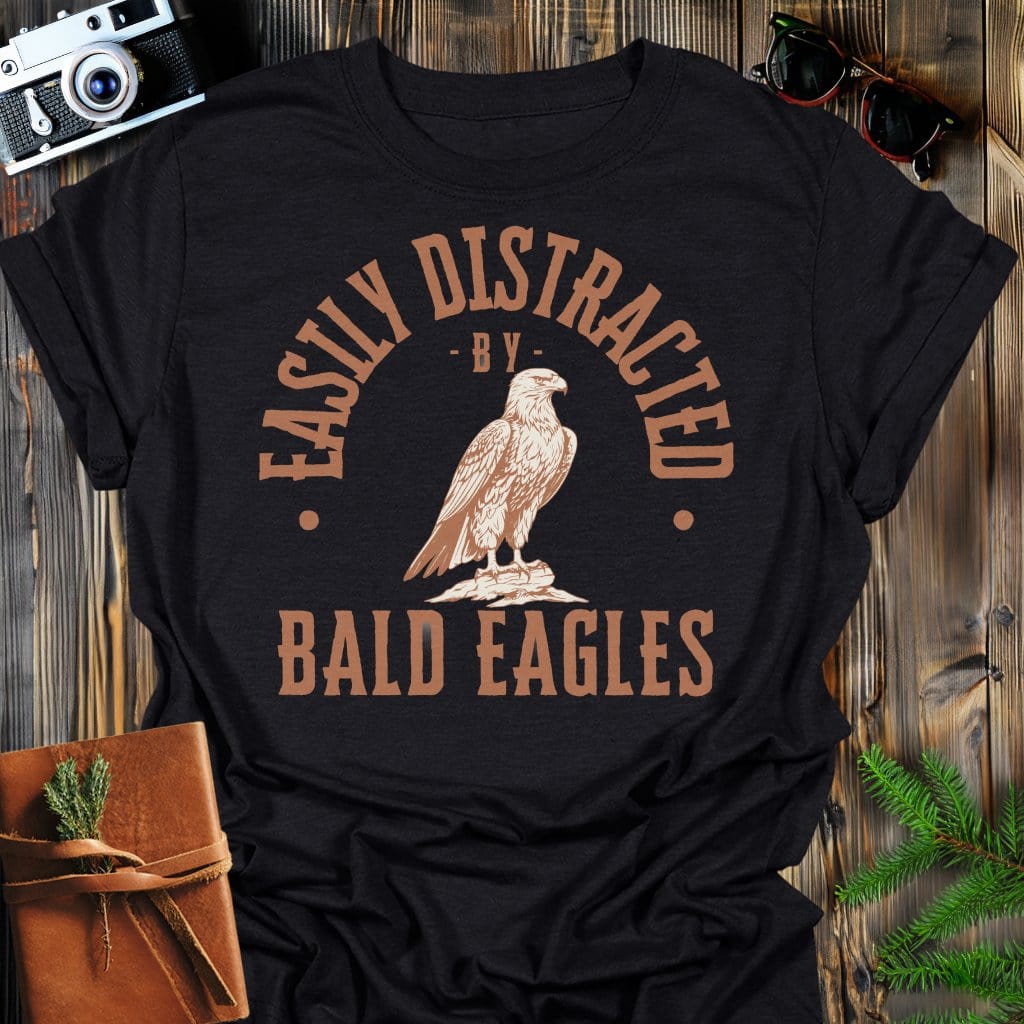 Distracted by Bald Eagles T-Shirt In S / Black Lightweight adventure tee for outdoor lovers Perfect for hiking camping or road trips Made from soft breathable cotton for all-day comfort Ideal for nature lovers and adventurers FAYO Threads outdoor apparel remember Fun Awaits You Outside