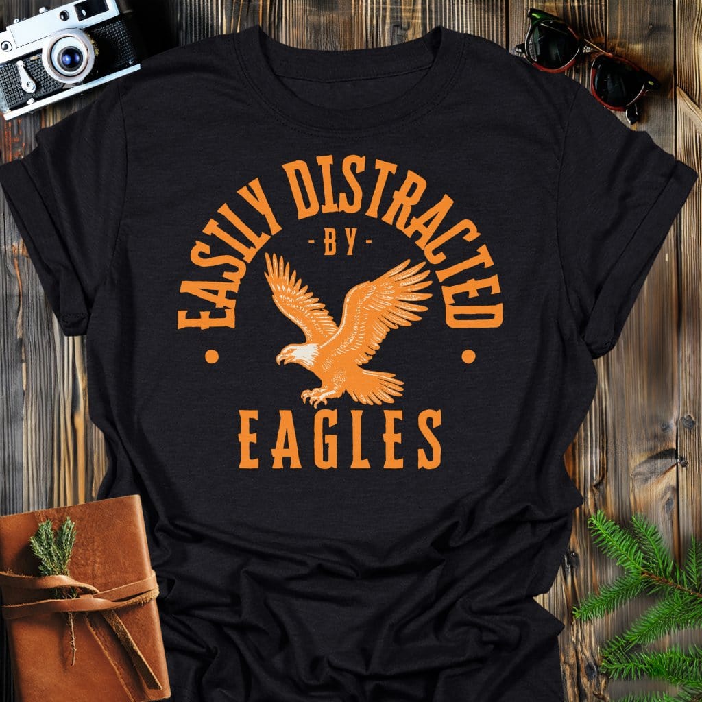 Distracted by Eagles T-Shirt In S / Black Lightweight adventure tee for outdoor lovers Perfect for hiking camping or road trips Made from soft breathable cotton for all-day comfort Ideal for nature lovers and adventurers FAYO Threads outdoor apparel remember Fun Awaits You Outside