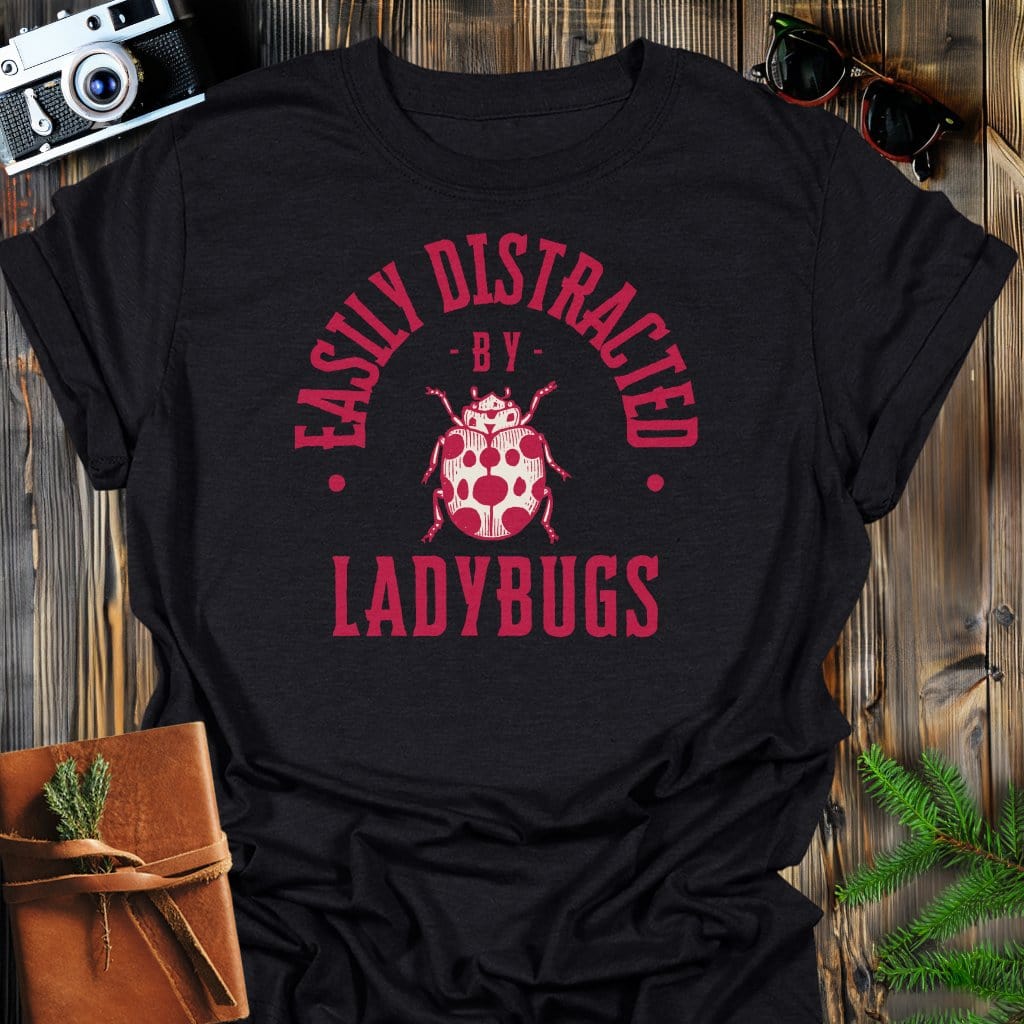 Distracted By Ladybugs T-Shirt In S / Black Lightweight adventure tee for outdoor lovers Perfect for hiking camping or road trips Made from soft breathable cotton for all-day comfort Ideal for nature lovers and adventurers FAYO Threads outdoor apparel remember Fun Awaits You Outside