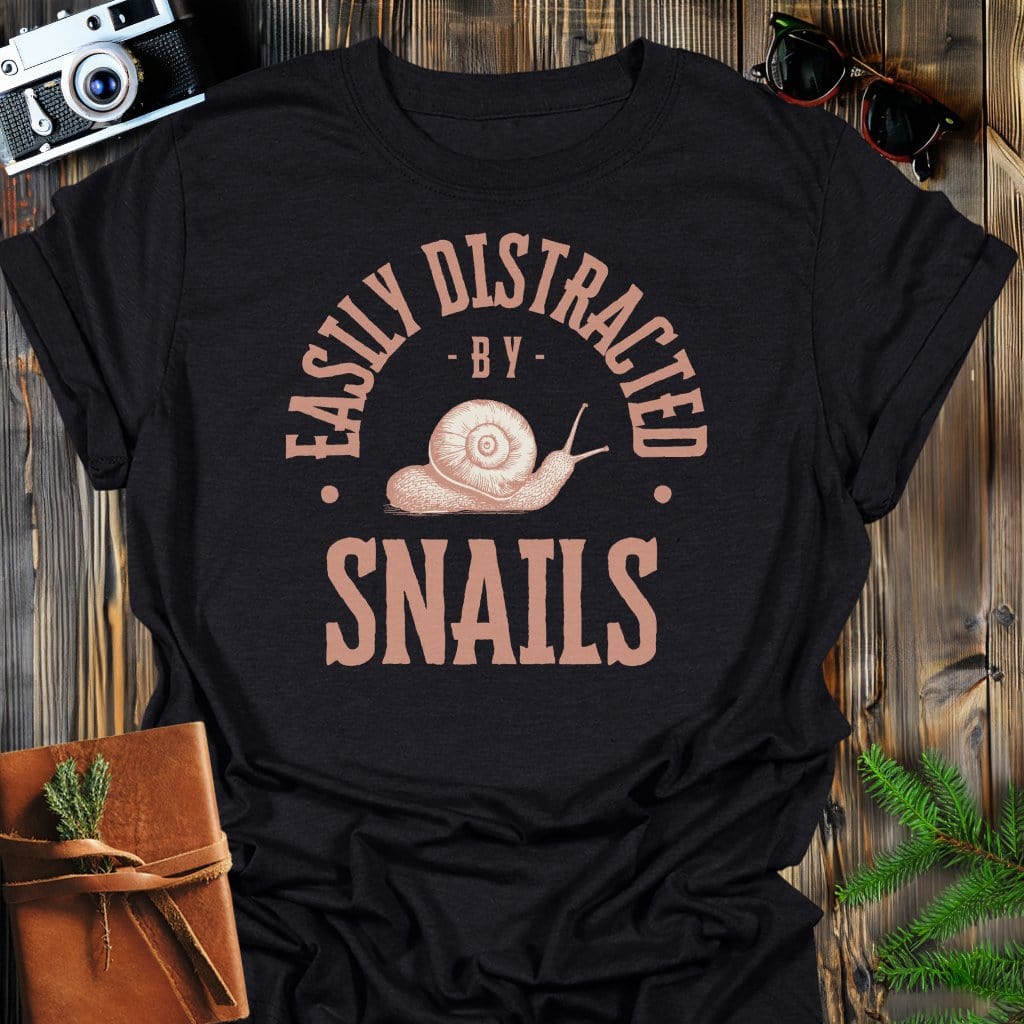 Distracted By Snails T-Shirt In S / Black Lightweight adventure tee for outdoor lovers Perfect for hiking camping or road trips Made from soft breathable cotton for all-day comfort Ideal for nature lovers and adventurers FAYO Threads outdoor apparel remember Fun Awaits You Outside