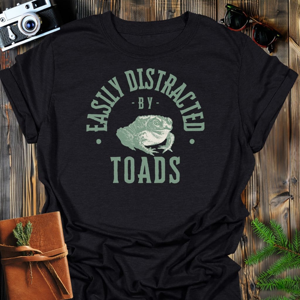 Distracted By Toads T-Shirt In S / Black Lightweight adventure tee for outdoor lovers Perfect for hiking camping or road trips Made from soft breathable cotton for all-day comfort Ideal for nature lovers and adventurers FAYO Threads outdoor apparel remember Fun Awaits You Outside