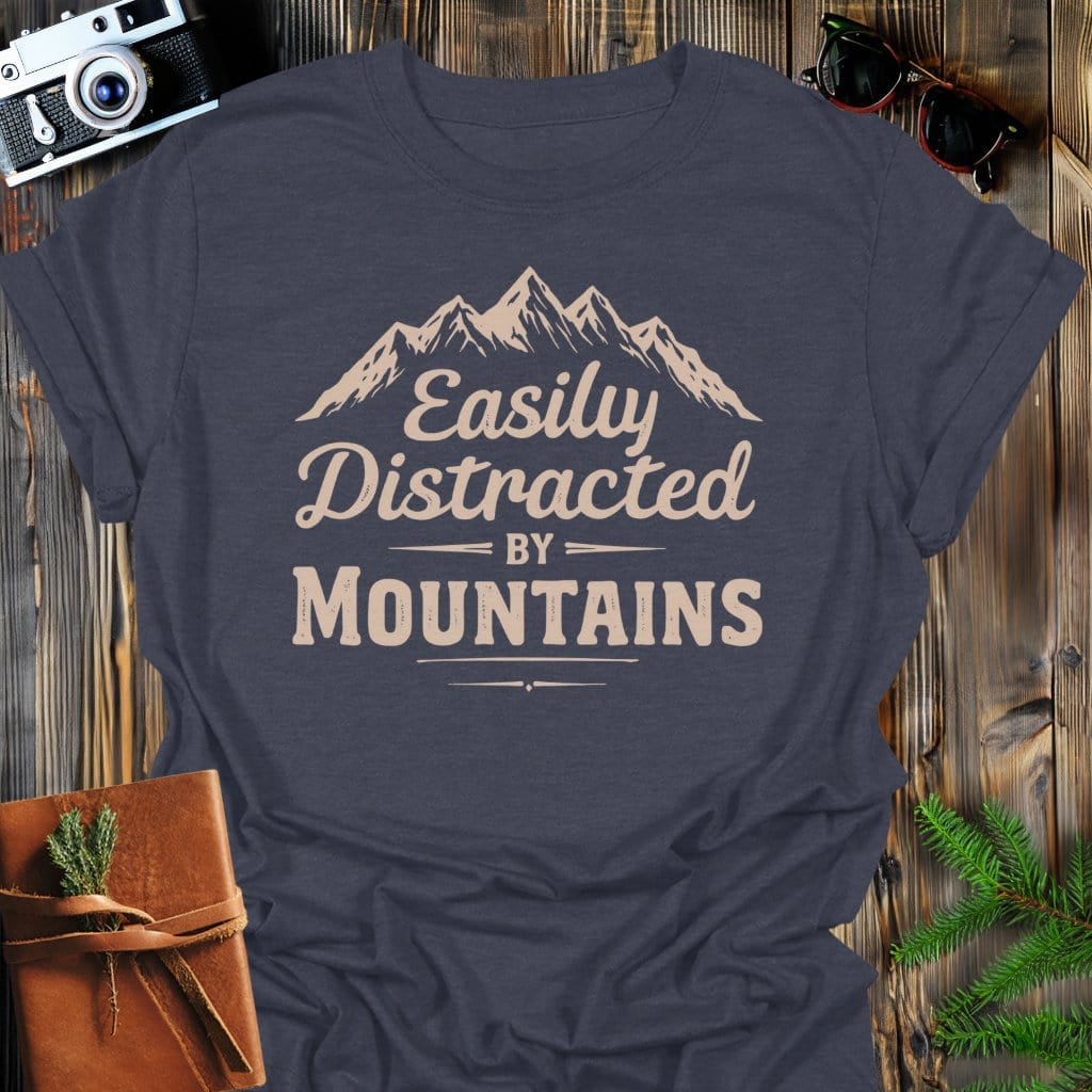 Distracted by Mountains T-Shirt In S / Dark Heather Lightweight adventure tee for outdoor lovers Perfect for hiking camping or road trips Made from soft breathable cotton for all-day comfort Ideal for nature lovers and adventurers FAYO Threads outdoor apparel remember Fun Awaits You Outside
