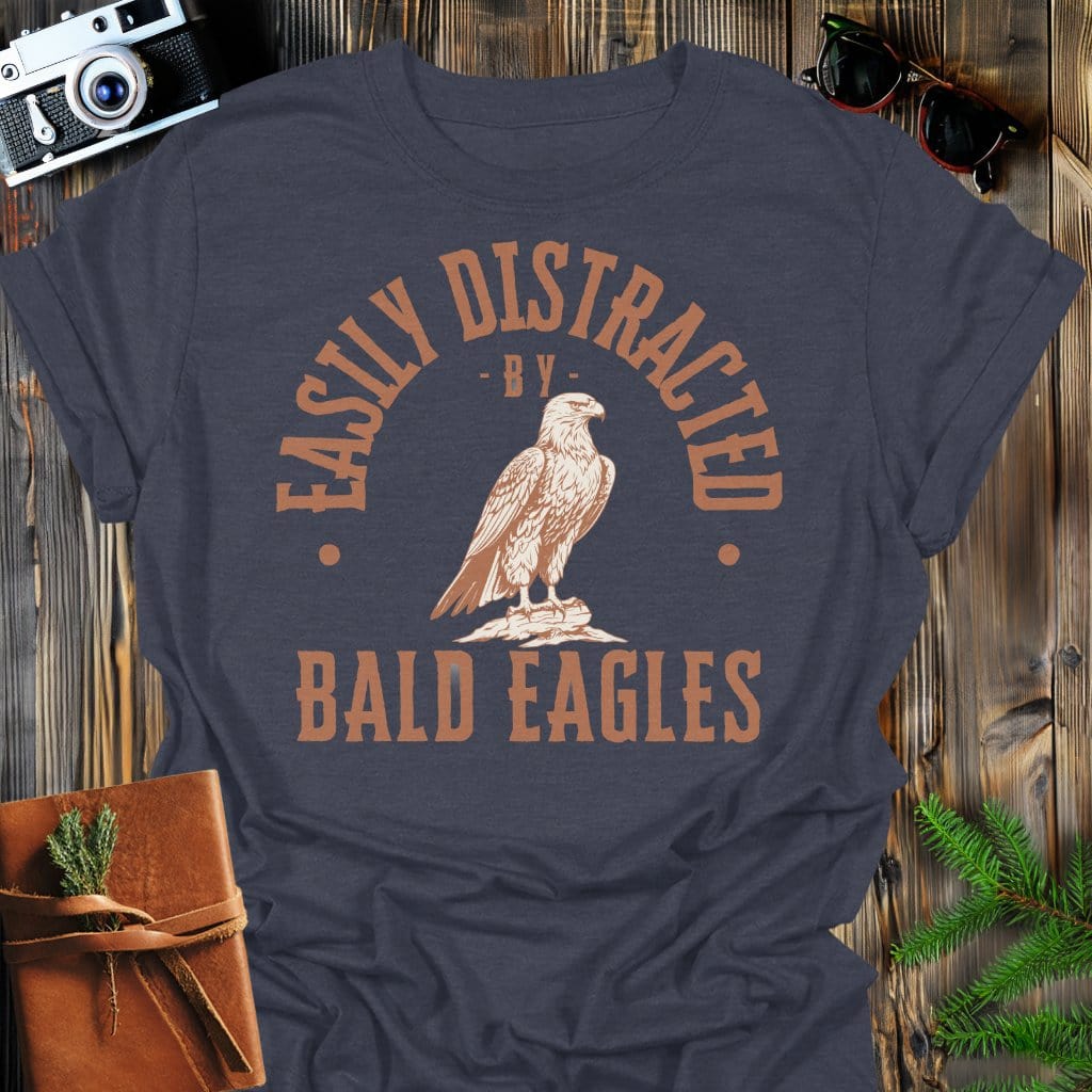 Distracted by Bald Eagles T-Shirt In S / Dark Heather Lightweight adventure tee for outdoor lovers Perfect for hiking camping or road trips Made from soft breathable cotton for all-day comfort Ideal for nature lovers and adventurers FAYO Threads outdoor apparel remember Fun Awaits You Outside