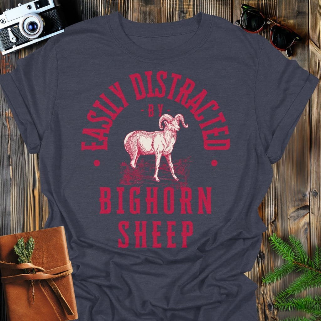 Distracted by Bighorn Sheep T-Shirt In S / Dark Heather Lightweight adventure tee for outdoor lovers Perfect for hiking camping or road trips Made from soft breathable cotton for all-day comfort Ideal for nature lovers and adventurers FAYO Threads outdoor apparel remember Fun Awaits You Outside