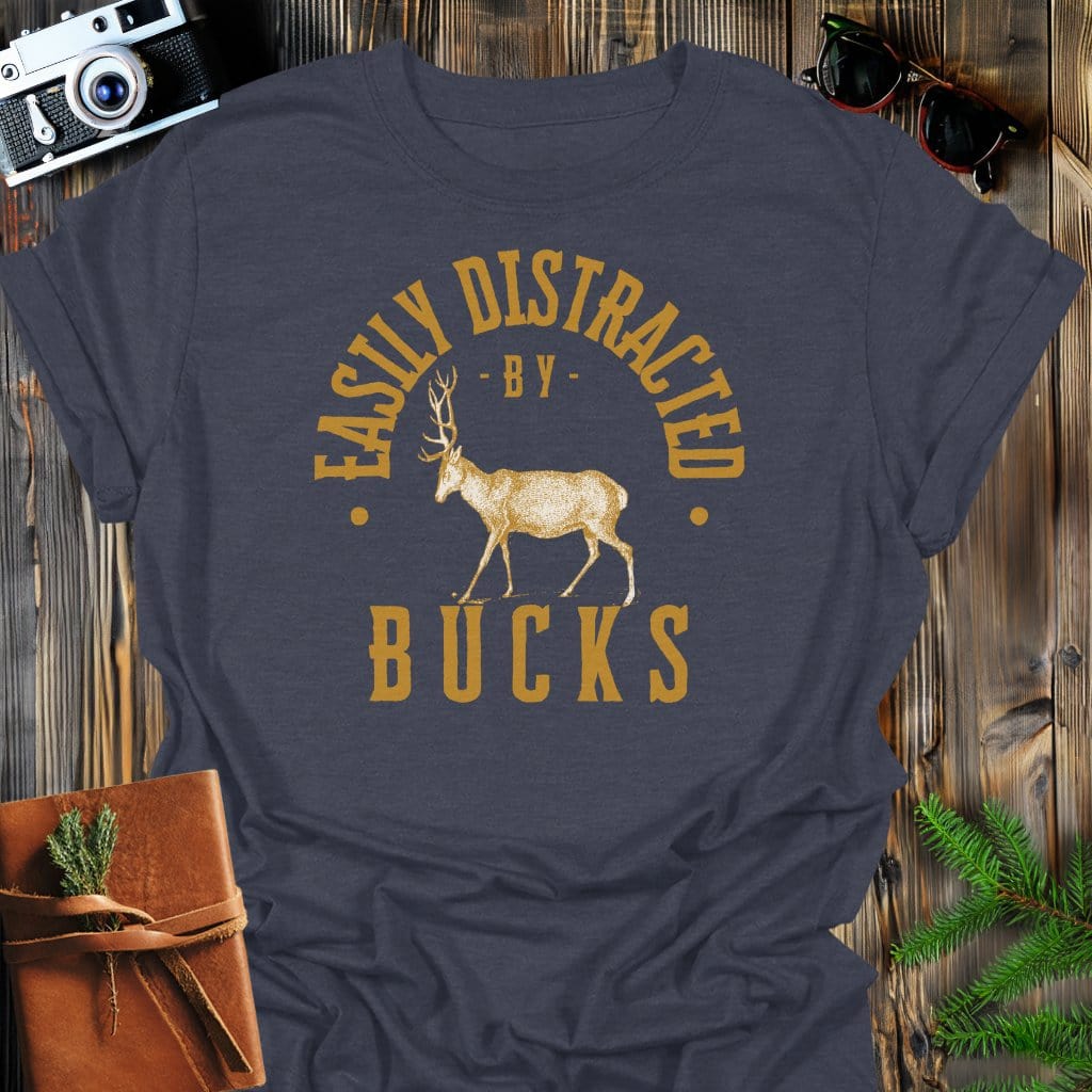 Distracted By Bucks T-Shirt In S / Dark Heather Lightweight adventure tee for outdoor lovers Perfect for hiking camping or road trips Made from soft breathable cotton for all-day comfort Ideal for nature lovers and adventurers FAYO Threads outdoor apparel remember Fun Awaits You Outside