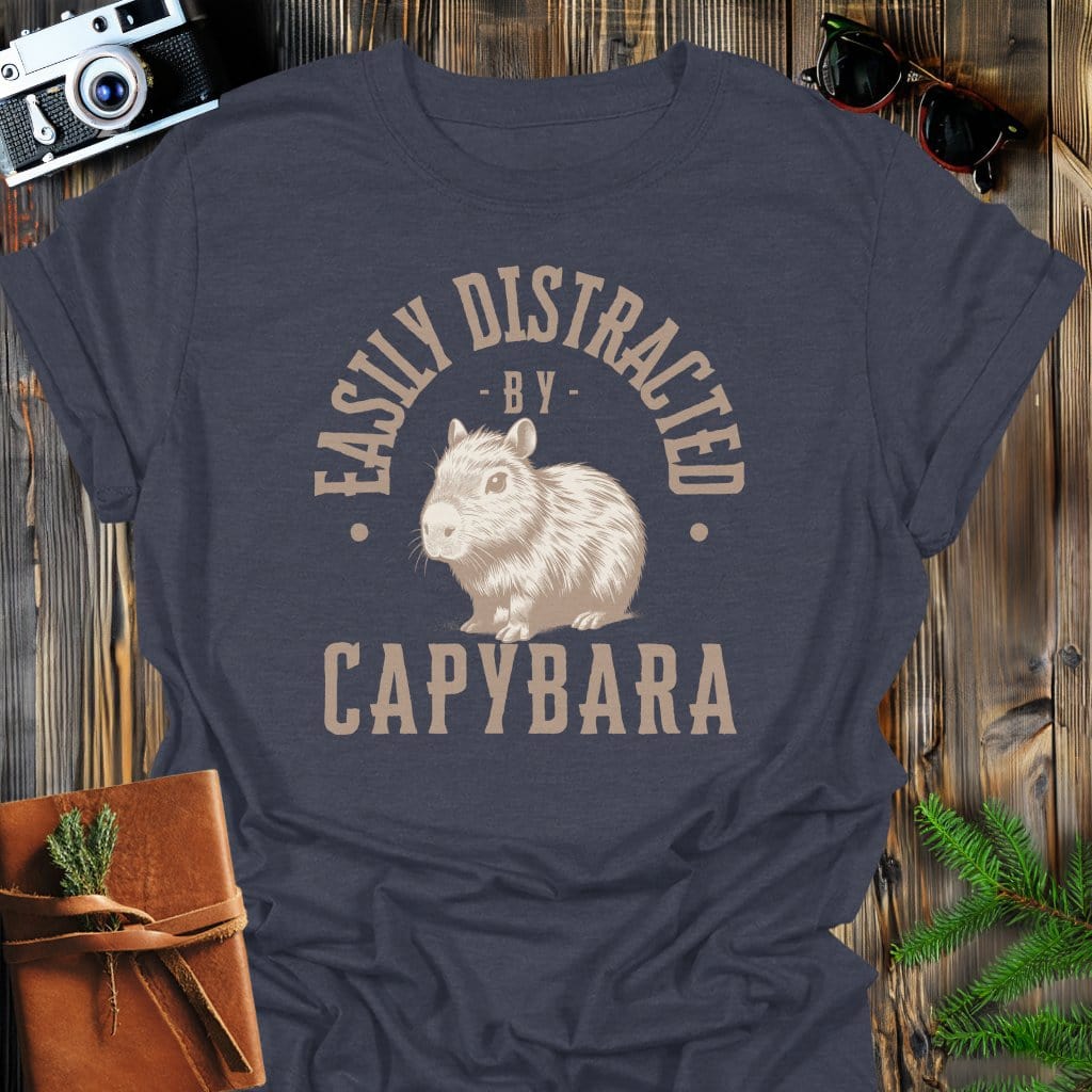 Distracted by Capybara T-Shirt In S / Dark Heather Lightweight adventure tee for outdoor lovers Perfect for hiking camping or road trips Made from soft breathable cotton for all-day comfort Ideal for nature lovers and adventurers FAYO Threads outdoor apparel remember Fun Awaits You Outside