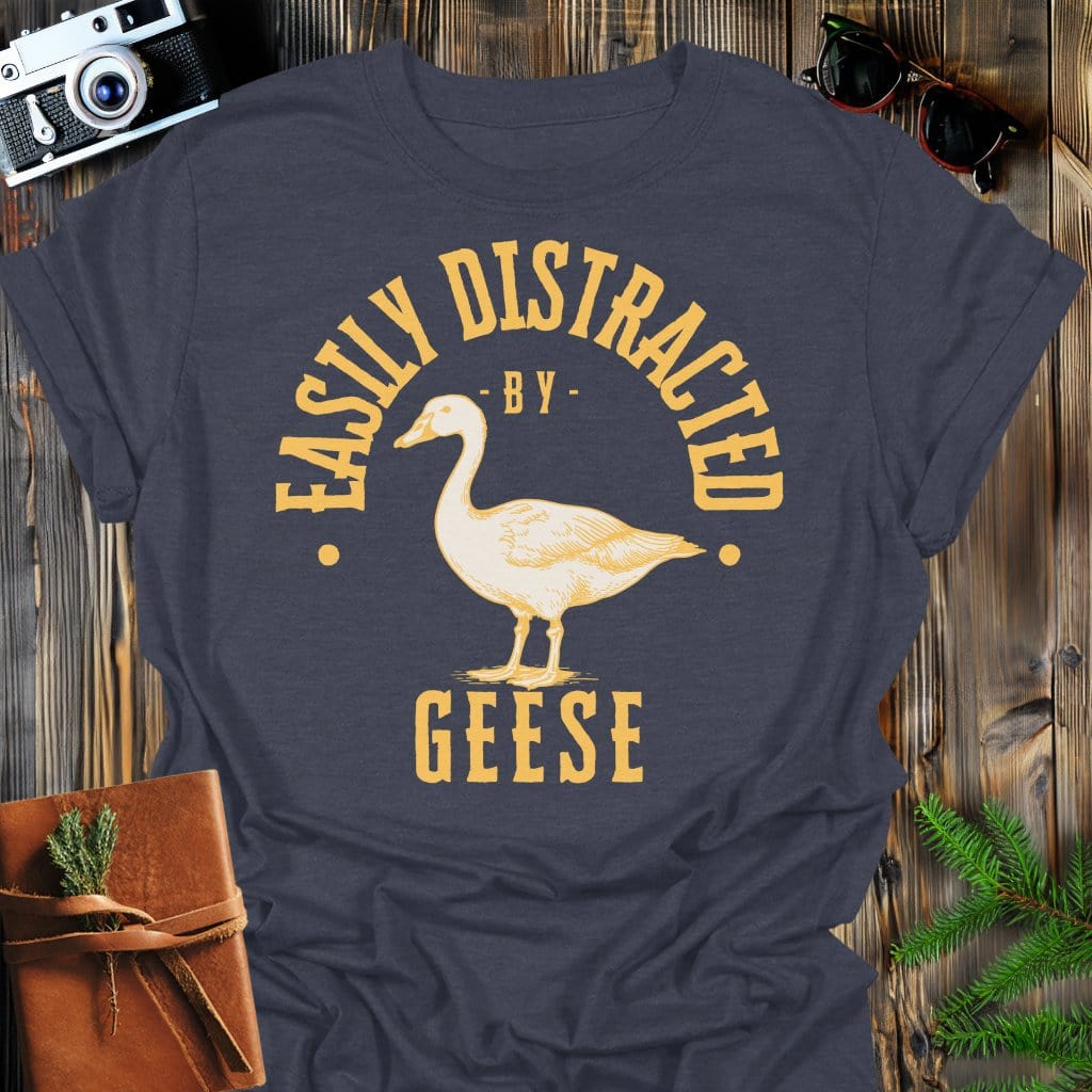 Distracted by Geese T-Shirt In S / Dark Heather Lightweight adventure tee for outdoor lovers Perfect for hiking camping or road trips Made from soft breathable cotton for all-day comfort Ideal for nature lovers and adventurers FAYO Threads outdoor apparel remember Fun Awaits You Outside