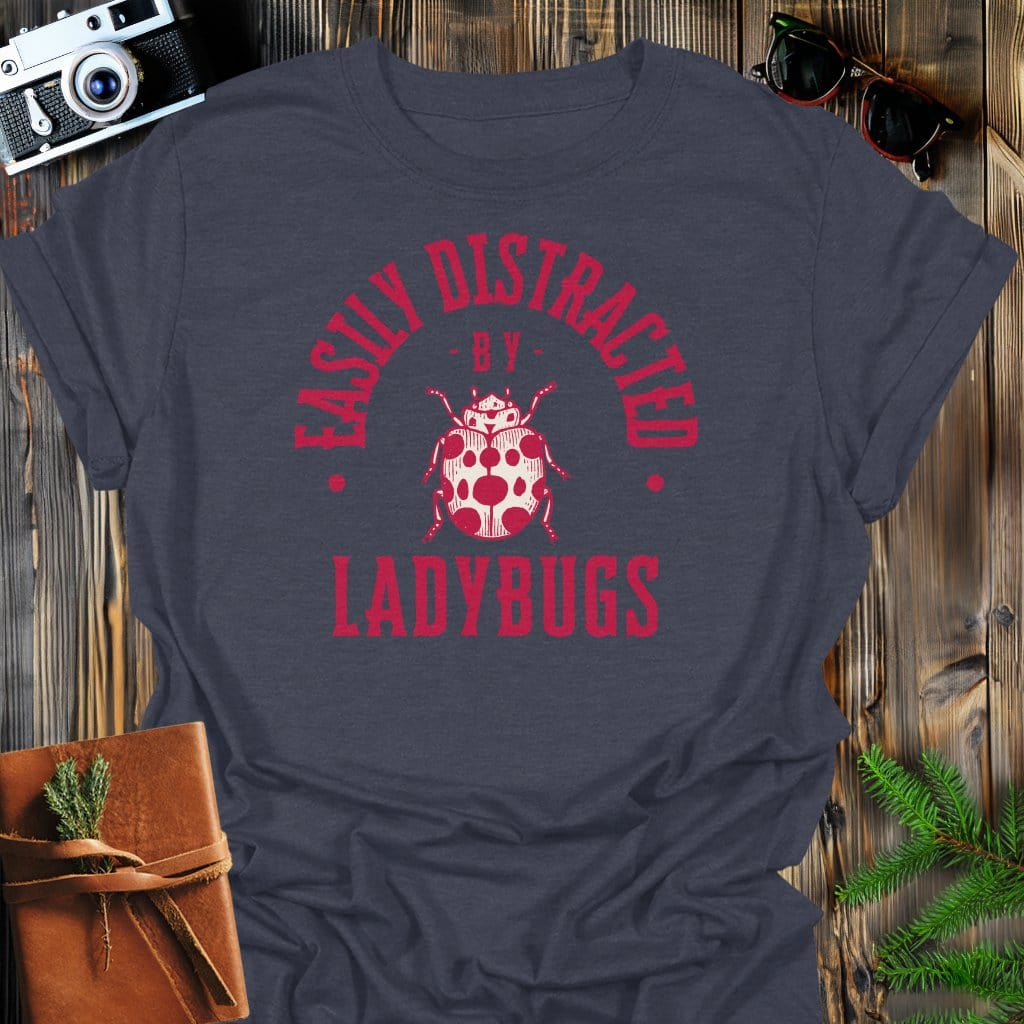 Distracted By Ladybugs T-Shirt In S / Dark Heather Lightweight adventure tee for outdoor lovers Perfect for hiking camping or road trips Made from soft breathable cotton for all-day comfort Ideal for nature lovers and adventurers FAYO Threads outdoor apparel remember Fun Awaits You Outside