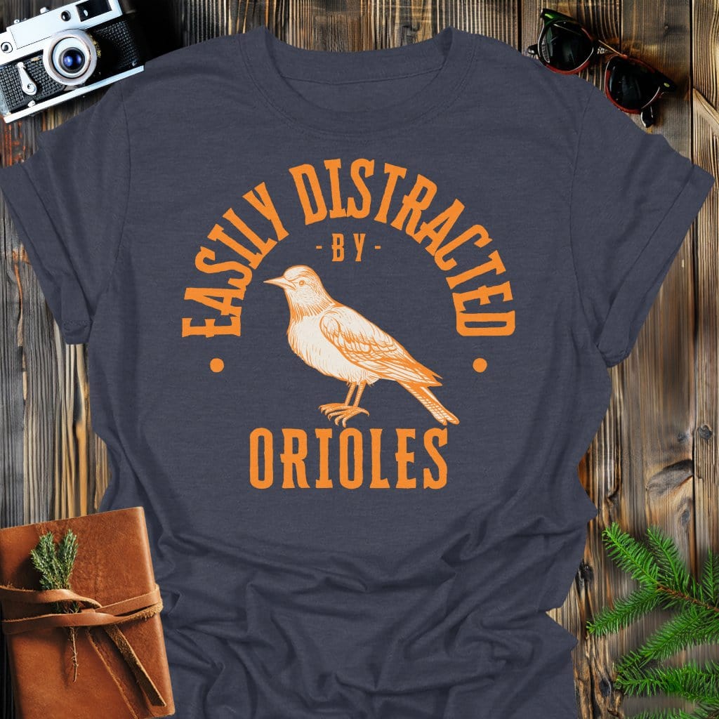 Distracted by Orioles T-Shirt In S / Dark Heather Lightweight adventure tee for outdoor lovers Perfect for hiking camping or road trips Made from soft breathable cotton for all-day comfort Ideal for nature lovers and adventurers FAYO Threads outdoor apparel remember Fun Awaits You Outside