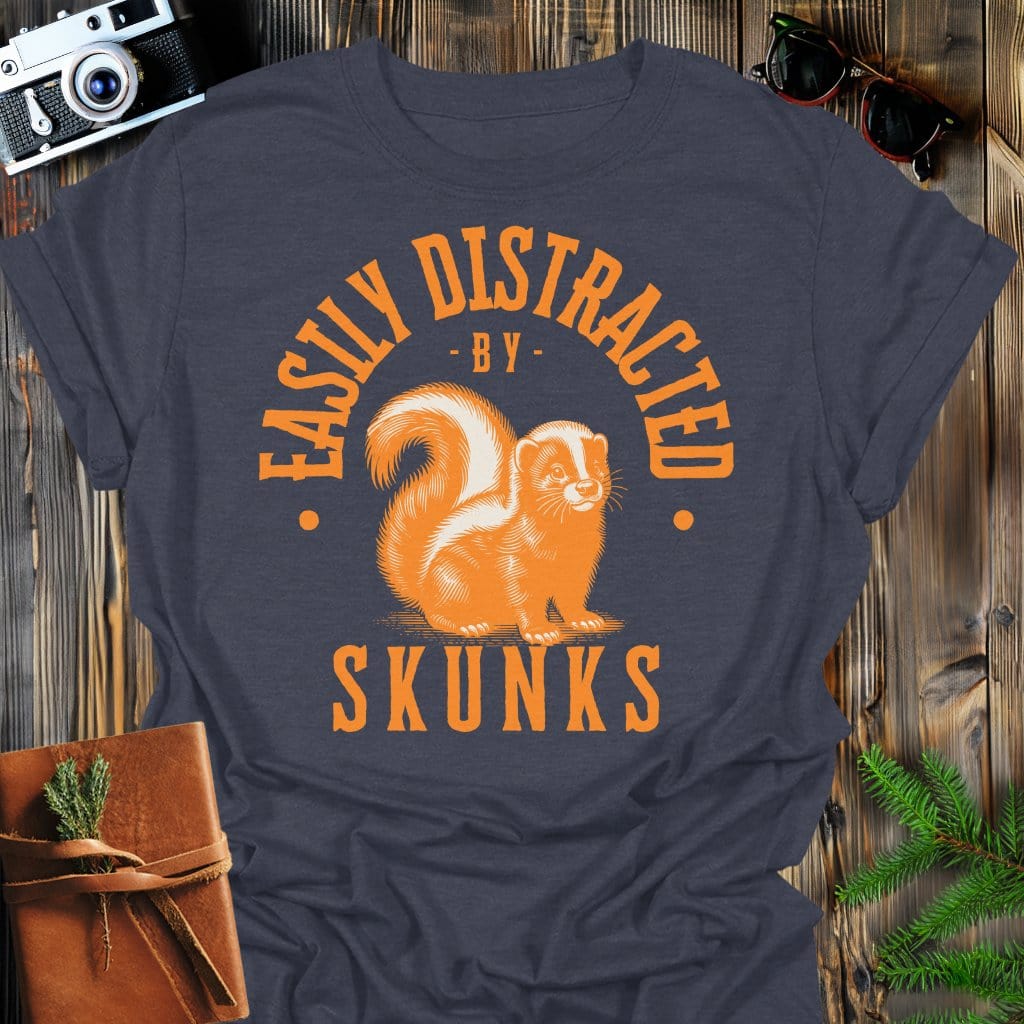Distracted by Skunks T-Shirt In S / Dark Heather Lightweight adventure tee for outdoor lovers Perfect for hiking camping or road trips Made from soft breathable cotton for all-day comfort Ideal for nature lovers and adventurers FAYO Threads outdoor apparel remember Fun Awaits You Outside