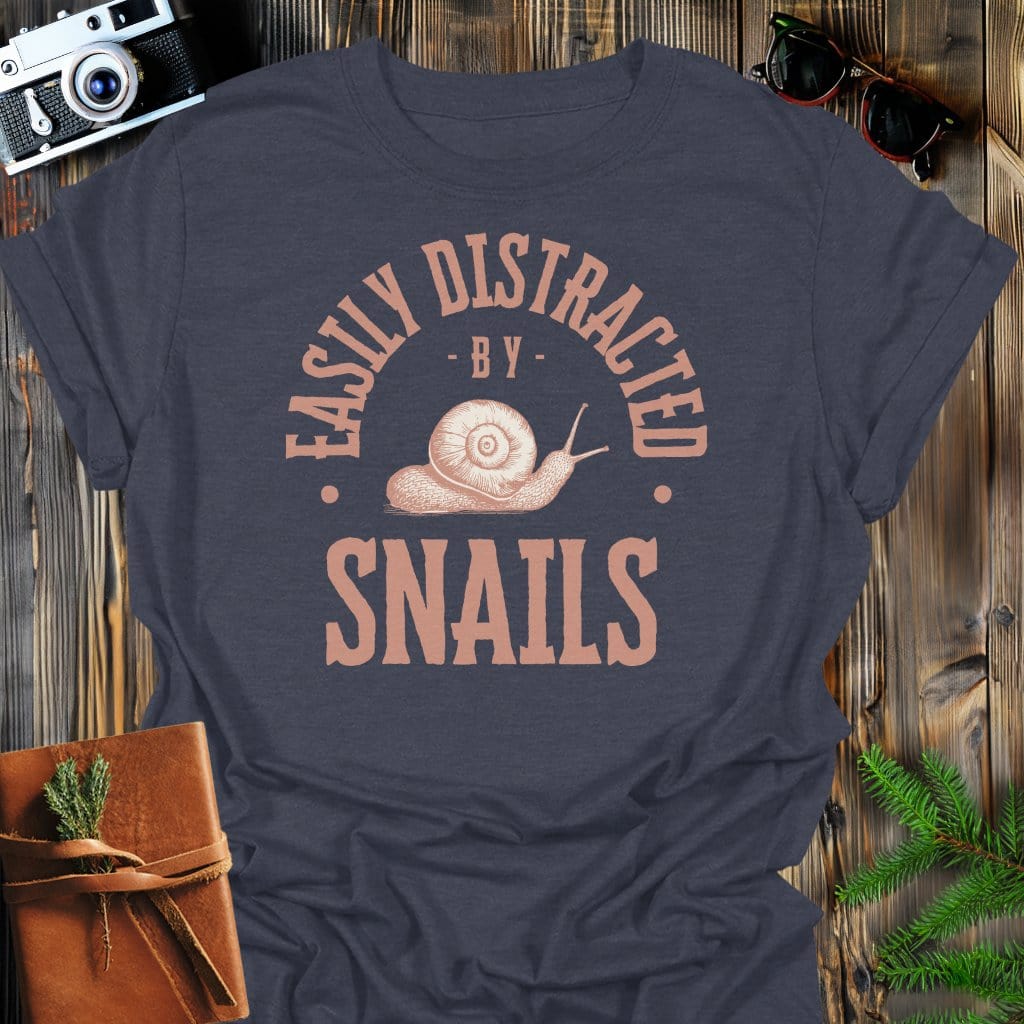 Distracted By Snails T-Shirt In S / Dark Heather Lightweight adventure tee for outdoor lovers Perfect for hiking camping or road trips Made from soft breathable cotton for all-day comfort Ideal for nature lovers and adventurers FAYO Threads outdoor apparel remember Fun Awaits You Outside