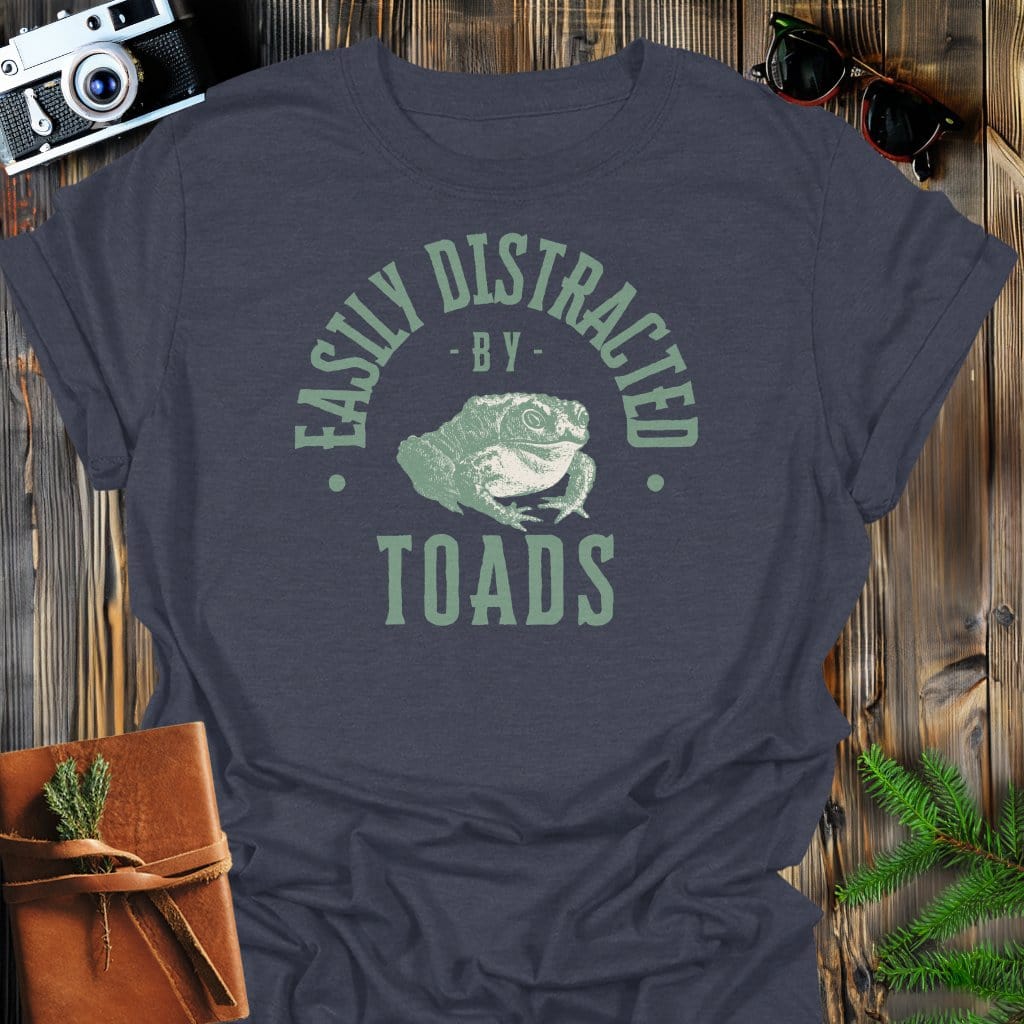 Distracted By Toads T-Shirt In S / Dark Heather Lightweight adventure tee for outdoor lovers Perfect for hiking camping or road trips Made from soft breathable cotton for all-day comfort Ideal for nature lovers and adventurers FAYO Threads outdoor apparel remember Fun Awaits You Outside