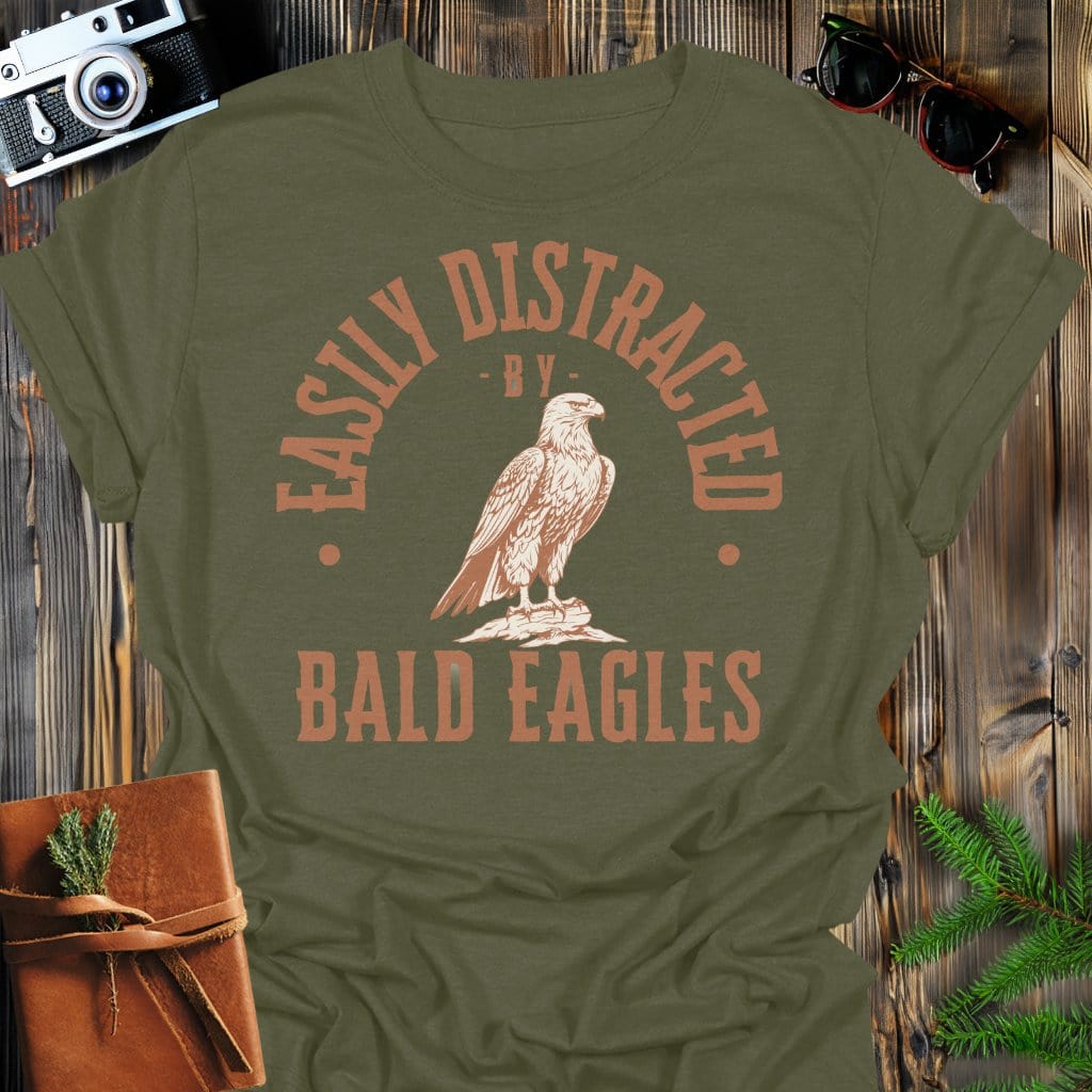 Distracted by Bald Eagles T-Shirt In S / Military Green Lightweight adventure tee for outdoor lovers Perfect for hiking camping or road trips Made from soft breathable cotton for all-day comfort Ideal for nature lovers and adventurers FAYO Threads outdoor apparel remember Fun Awaits You Outside