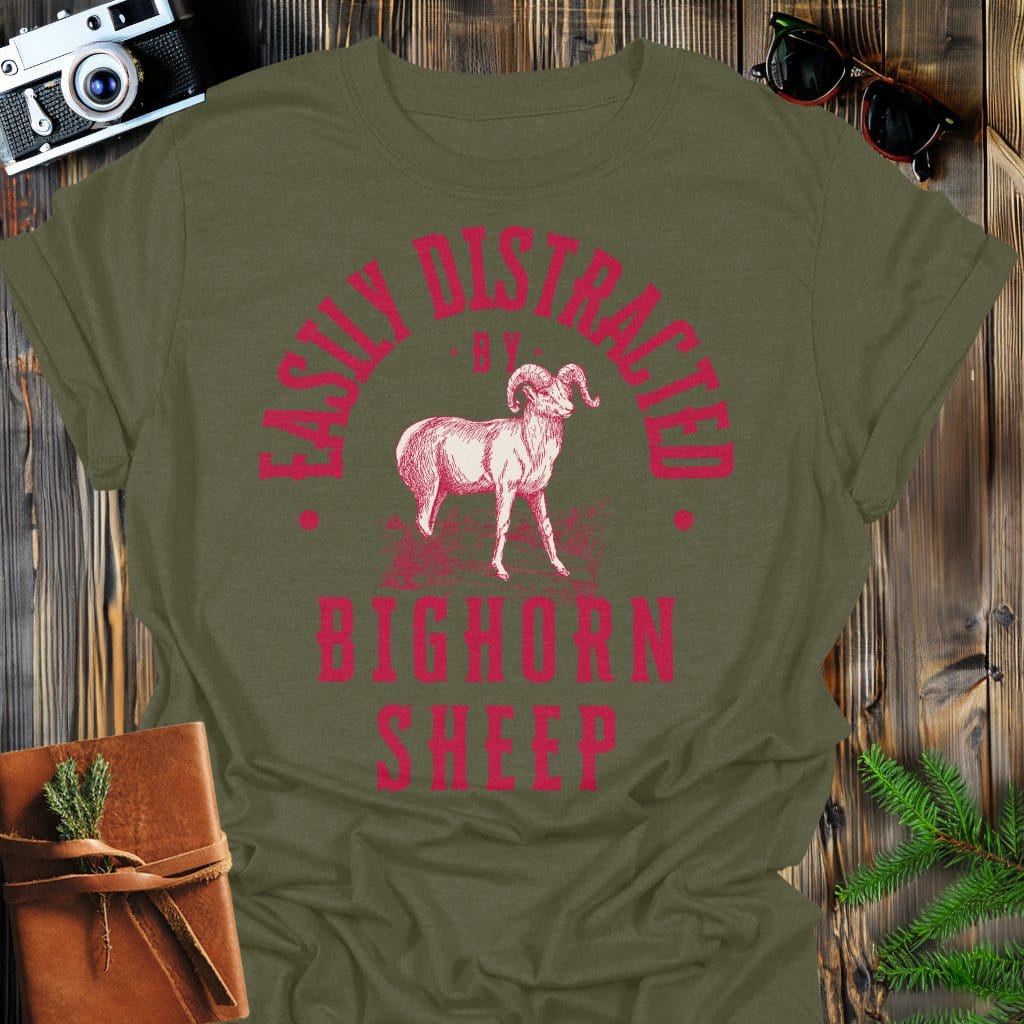 Distracted by Bighorn Sheep T-Shirt In S / Military Green Lightweight adventure tee for outdoor lovers Perfect for hiking camping or road trips Made from soft breathable cotton for all-day comfort Ideal for nature lovers and adventurers FAYO Threads outdoor apparel remember Fun Awaits You Outside
