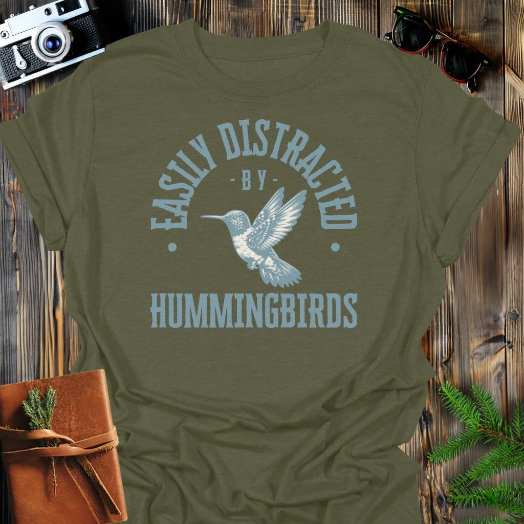 Distracted By Hummingbirds T-Shirt In S / Military Green Lightweight adventure tee for outdoor lovers Perfect for hiking camping or road trips Made from soft breathable cotton for all-day comfort Ideal for nature lovers and adventurers FAYO Threads outdoor apparel remember Fun Awaits You Outside