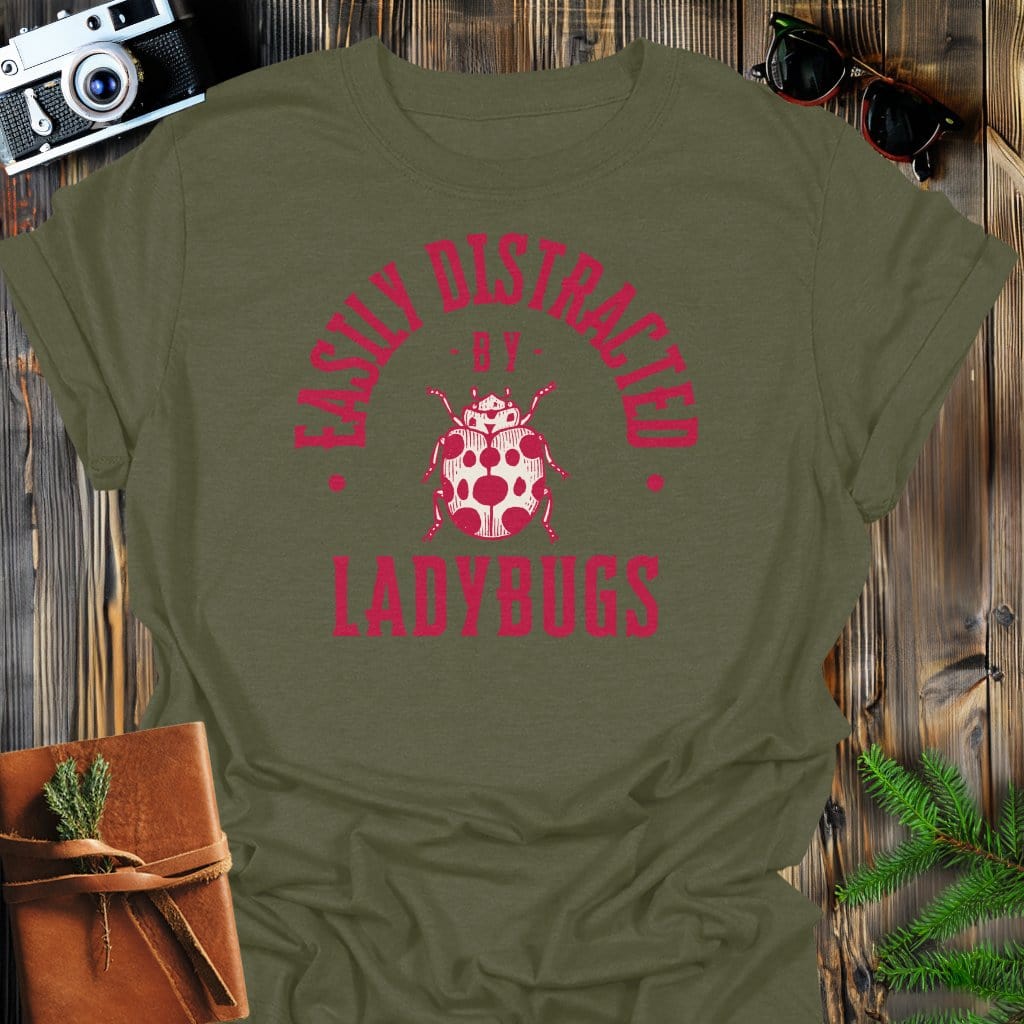 Distracted By Ladybugs T-Shirt In S / Military Green Lightweight adventure tee for outdoor lovers Perfect for hiking camping or road trips Made from soft breathable cotton for all-day comfort Ideal for nature lovers and adventurers FAYO Threads outdoor apparel remember Fun Awaits You Outside