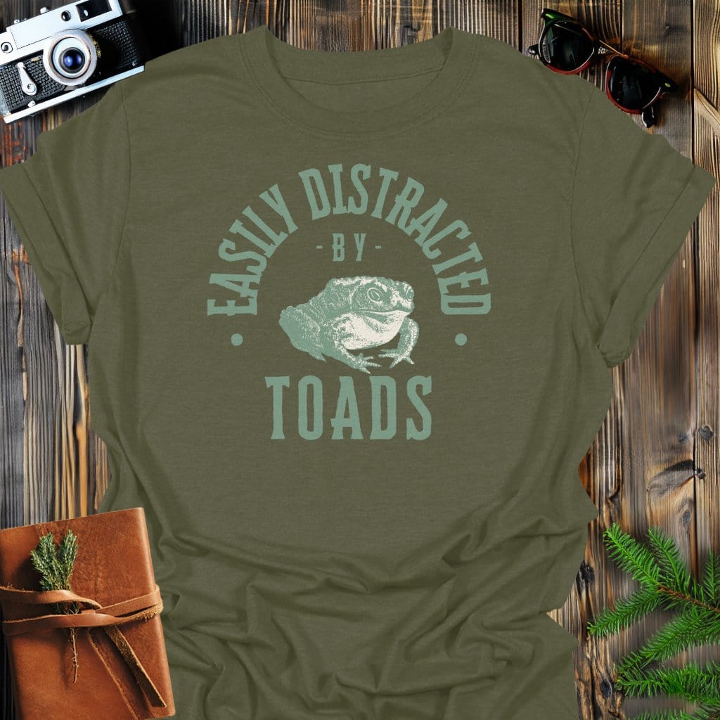 Distracted By Toads T-Shirt In S / Military Green Lightweight adventure tee for outdoor lovers Perfect for hiking camping or road trips Made from soft breathable cotton for all-day comfort Ideal for nature lovers and adventurers FAYO Threads outdoor apparel remember Fun Awaits You Outside