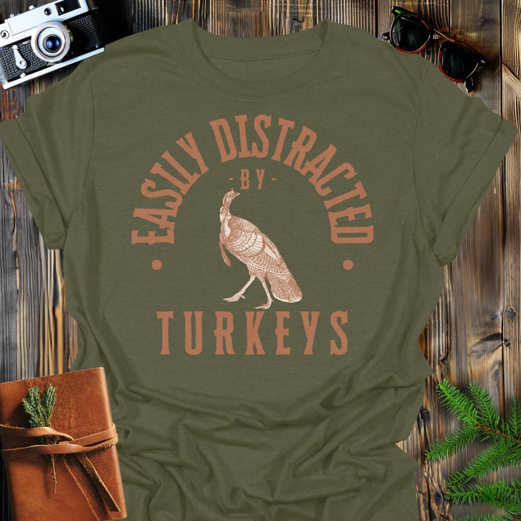 Distracted by Turkeys T-Shirt In S / Military Green Lightweight adventure tee for outdoor lovers Perfect for hiking camping or road trips Made from soft breathable cotton for all-day comfort Ideal for nature lovers and adventurers FAYO Threads outdoor apparel remember Fun Awaits You Outside