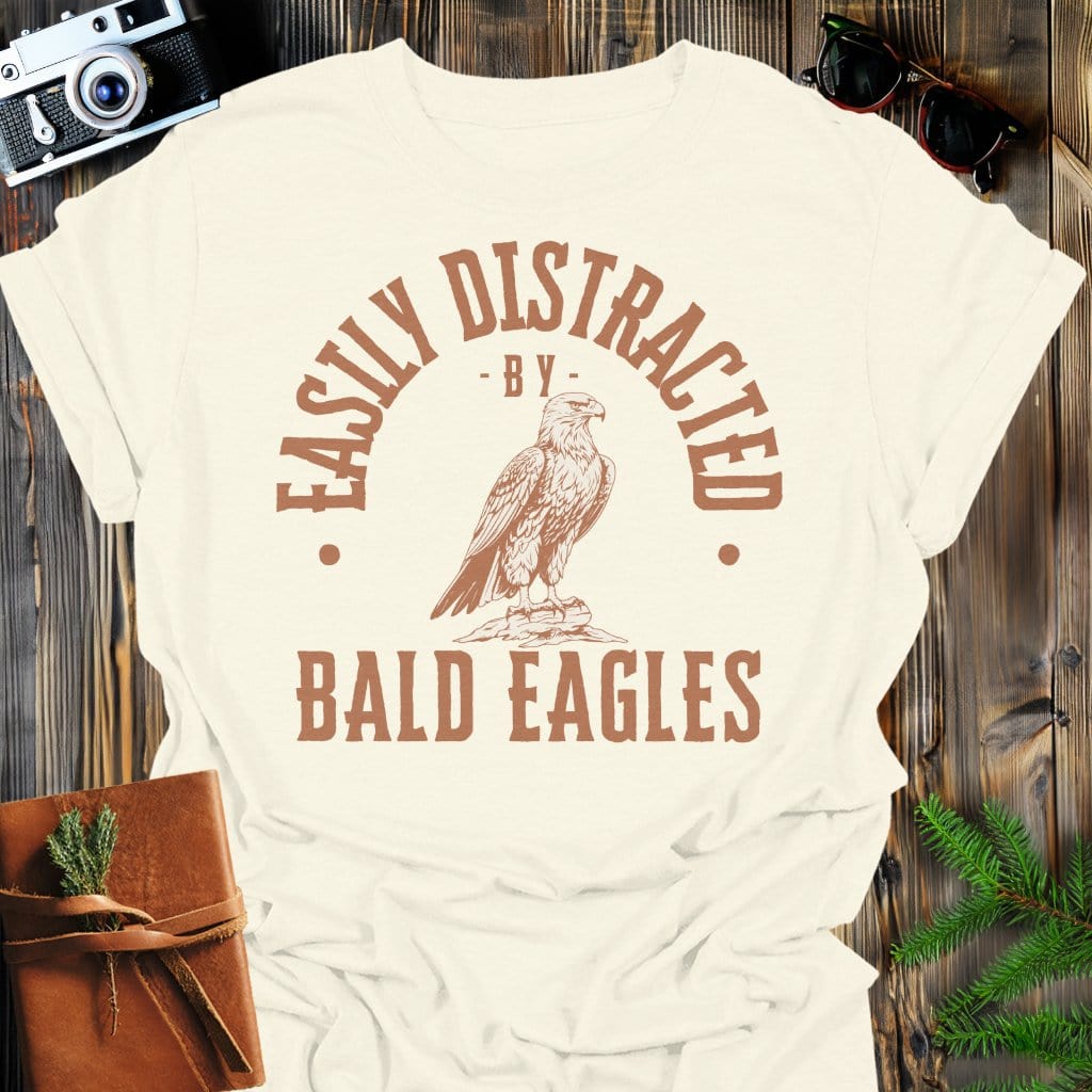 Distracted by Bald Eagles T-Shirt In S / Natural Lightweight adventure tee for outdoor lovers Perfect for hiking camping or road trips Made from soft breathable cotton for all-day comfort Ideal for nature lovers and adventurers FAYO Threads outdoor apparel remember Fun Awaits You Outside
