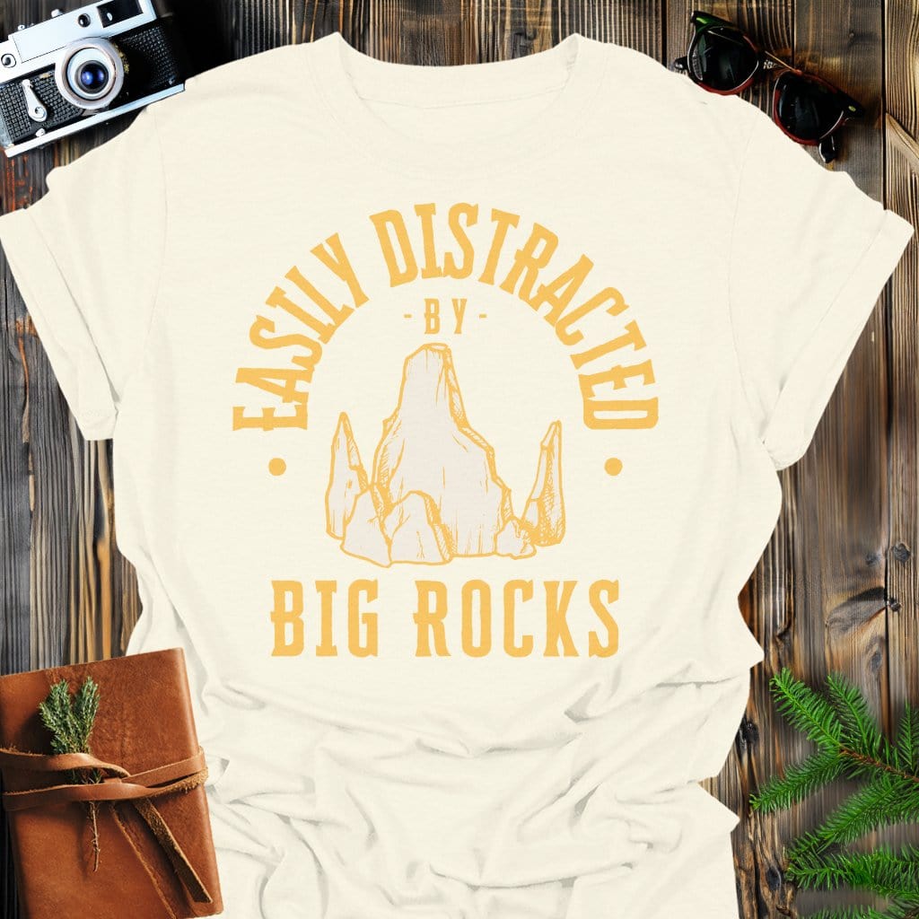 Distracted by Big Rocks T-Shirt In S / Natural Lightweight adventure tee for outdoor lovers Perfect for hiking camping or road trips Made from soft breathable cotton for all-day comfort Ideal for nature lovers and adventurers FAYO Threads outdoor apparel remember Fun Awaits You Outside