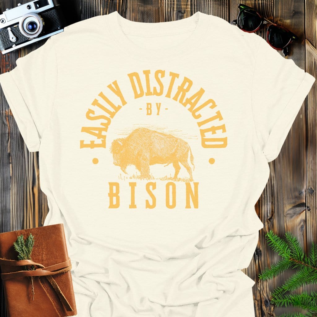 Distracted by Bison T-Shirt In S / Natural Lightweight adventure tee for outdoor lovers Perfect for hiking camping or road trips Made from soft breathable cotton for all-day comfort Ideal for nature lovers and adventurers FAYO Threads outdoor apparel remember Fun Awaits You Outside