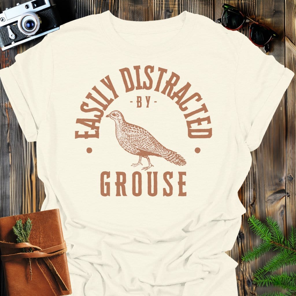 Distracted by Grouse T-Shirt In S / Natural Lightweight adventure tee for outdoor lovers Perfect for hiking camping or road trips Made from soft breathable cotton for all-day comfort Ideal for nature lovers and adventurers FAYO Threads outdoor apparel remember Fun Awaits You Outside