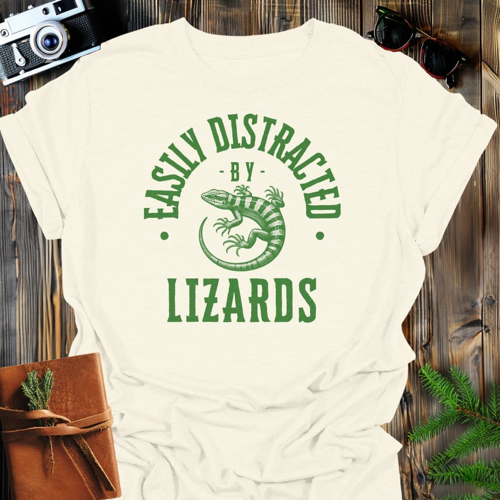 Distracted By Lizards T-Shirt In S / Natural Lightweight adventure tee for outdoor lovers Perfect for hiking camping or road trips Made from soft breathable cotton for all-day comfort Ideal for nature lovers and adventurers FAYO Threads outdoor apparel remember Fun Awaits You Outside