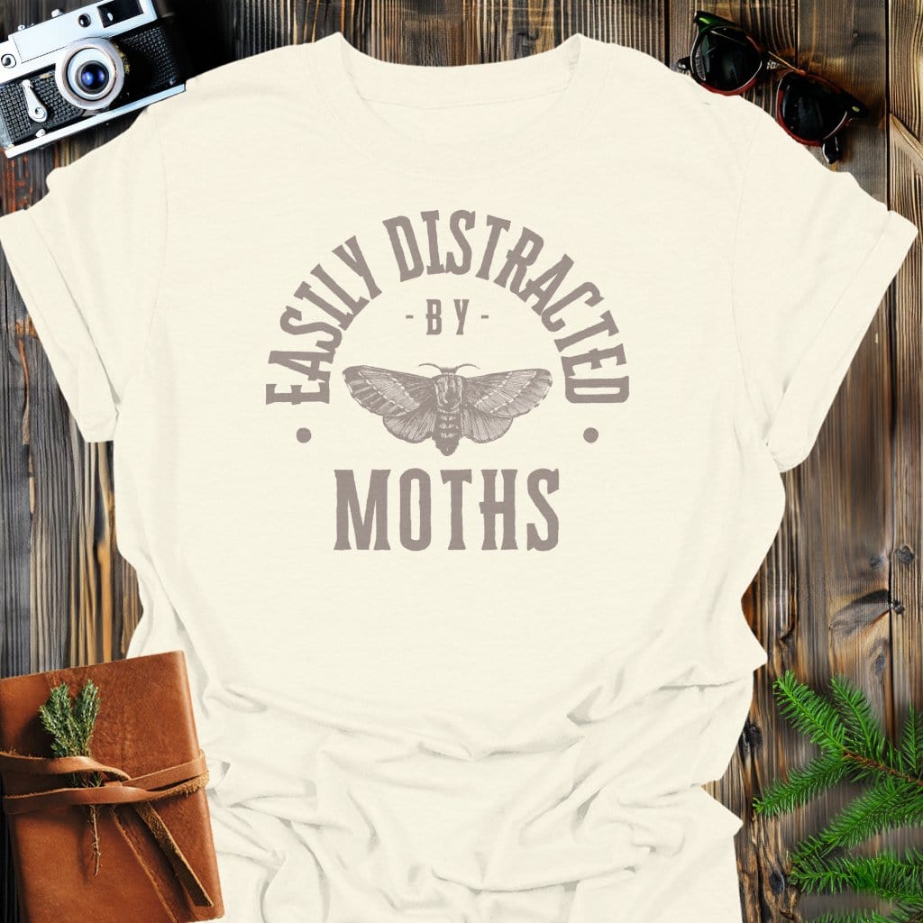 Distracted By Moths T-Shirt In S / Natural Lightweight adventure tee for outdoor lovers Perfect for hiking camping or road trips Made from soft breathable cotton for all-day comfort Ideal for nature lovers and adventurers FAYO Threads outdoor apparel remember Fun Awaits You Outside