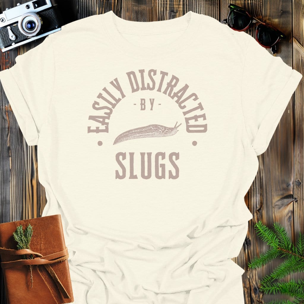 Distracted By Slugs T-Shirt In S / Natural Lightweight adventure tee for outdoor lovers Perfect for hiking camping or road trips Made from soft breathable cotton for all-day comfort Ideal for nature lovers and adventurers FAYO Threads outdoor apparel remember Fun Awaits You Outside