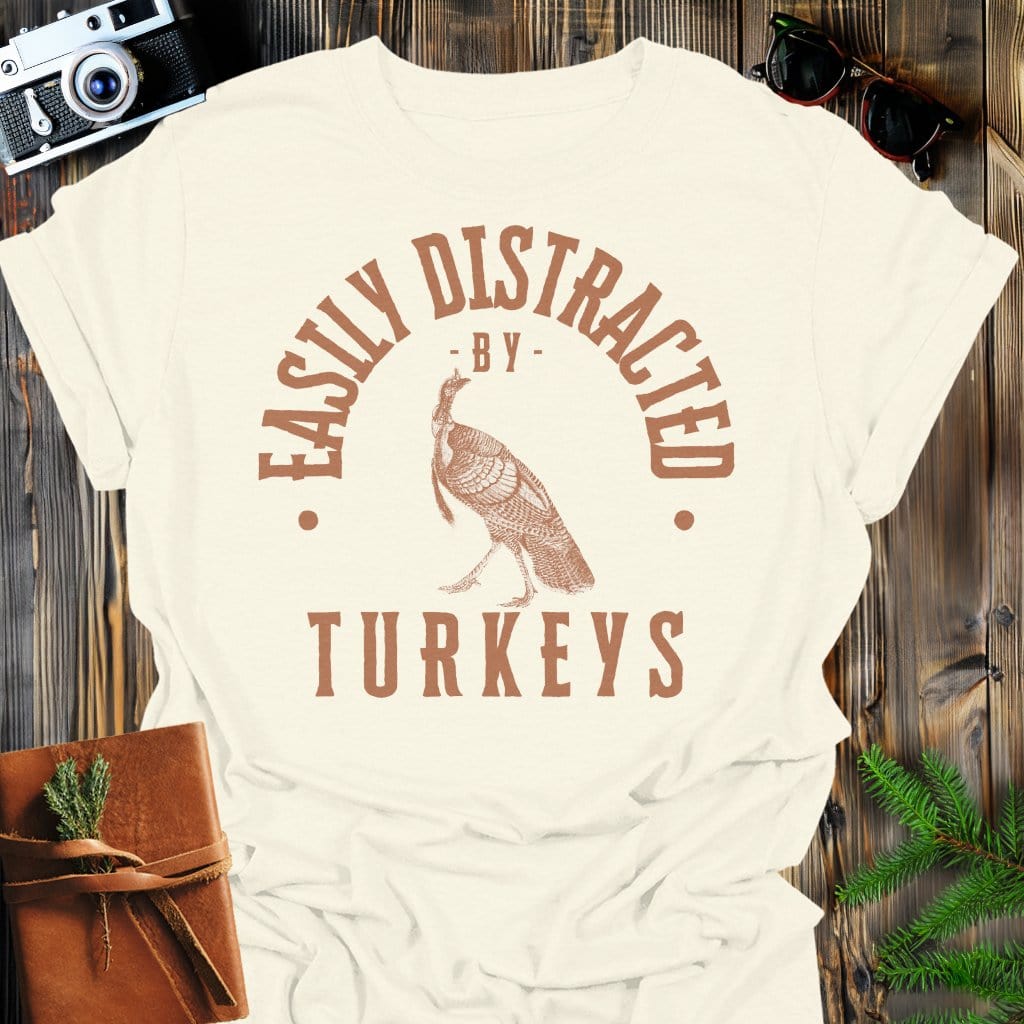 Distracted by Turkeys T-Shirt In S / Natural Lightweight adventure tee for outdoor lovers Perfect for hiking camping or road trips Made from soft breathable cotton for all-day comfort Ideal for nature lovers and adventurers FAYO Threads outdoor apparel remember Fun Awaits You Outside