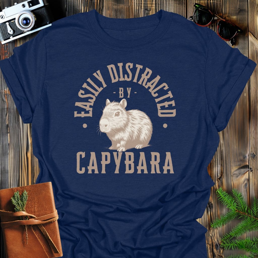 Distracted by Capybara T-Shirt In S / Navy Lightweight adventure tee for outdoor lovers Perfect for hiking camping or road trips Made from soft breathable cotton for all-day comfort Ideal for nature lovers and adventurers FAYO Threads outdoor apparel remember Fun Awaits You Outside