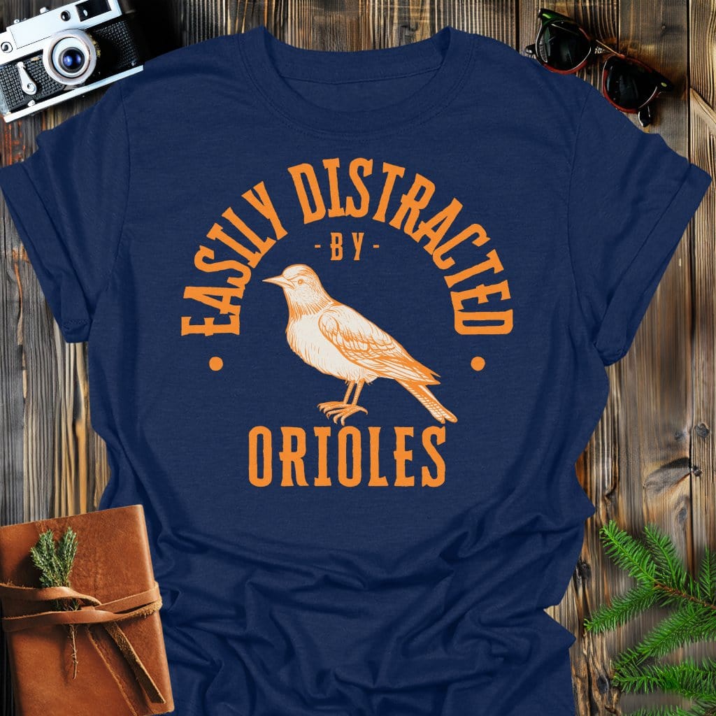 Distracted by Orioles T-Shirt In S / Navy Lightweight adventure tee for outdoor lovers Perfect for hiking camping or road trips Made from soft breathable cotton for all-day comfort Ideal for nature lovers and adventurers FAYO Threads outdoor apparel remember Fun Awaits You Outside