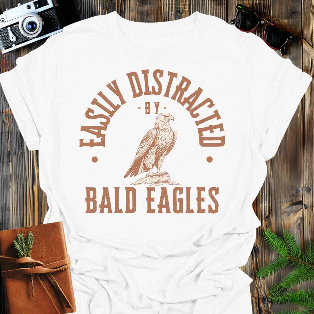 Distracted by Bald Eagles T-Shirt In S / White Lightweight adventure tee for outdoor lovers Perfect for hiking camping or road trips Made from soft breathable cotton for all-day comfort Ideal for nature lovers and adventurers FAYO Threads outdoor apparel remember Fun Awaits You Outside
