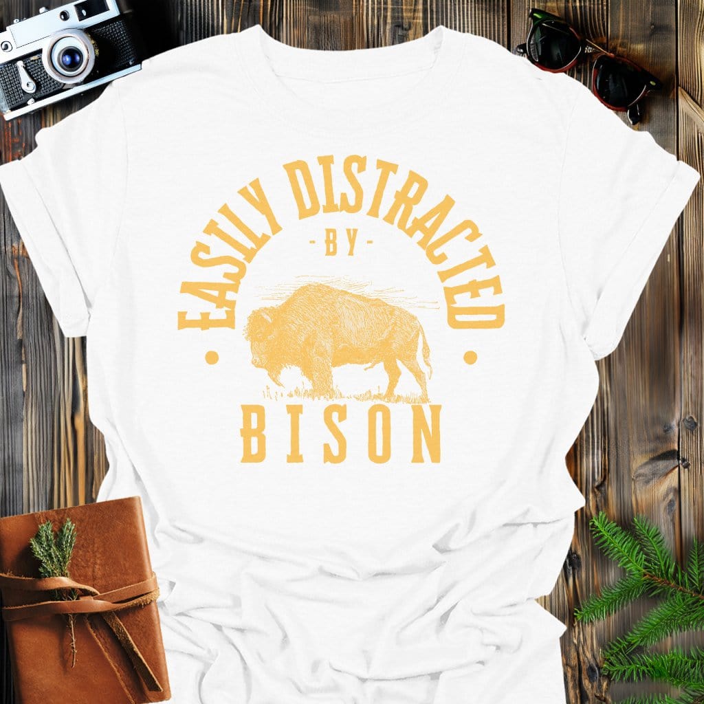 Distracted by Bison T-Shirt In S / White Lightweight adventure tee for outdoor lovers Perfect for hiking camping or road trips Made from soft breathable cotton for all-day comfort Ideal for nature lovers and adventurers FAYO Threads outdoor apparel remember Fun Awaits You Outside