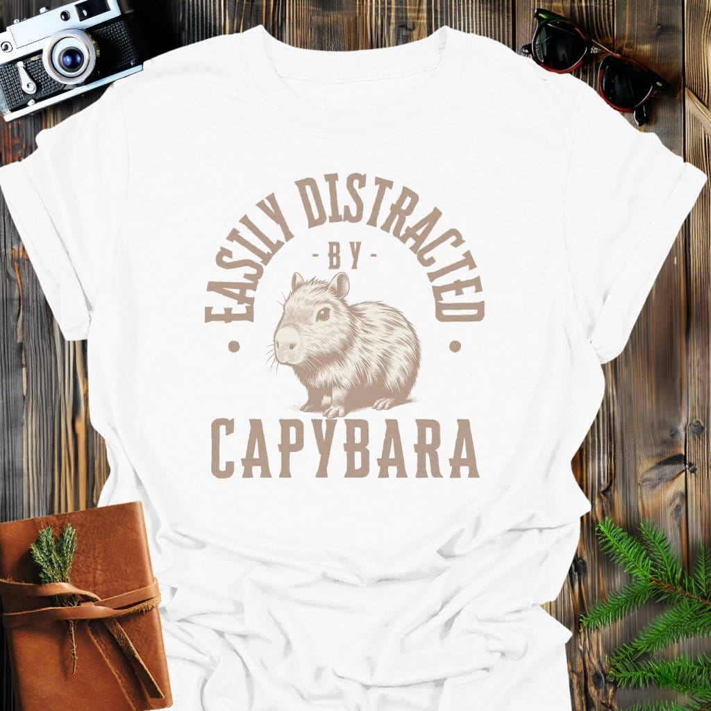 Distracted by Capybara T-Shirt In S / White Lightweight adventure tee for outdoor lovers Perfect for hiking camping or road trips Made from soft breathable cotton for all-day comfort Ideal for nature lovers and adventurers FAYO Threads outdoor apparel remember Fun Awaits You Outside