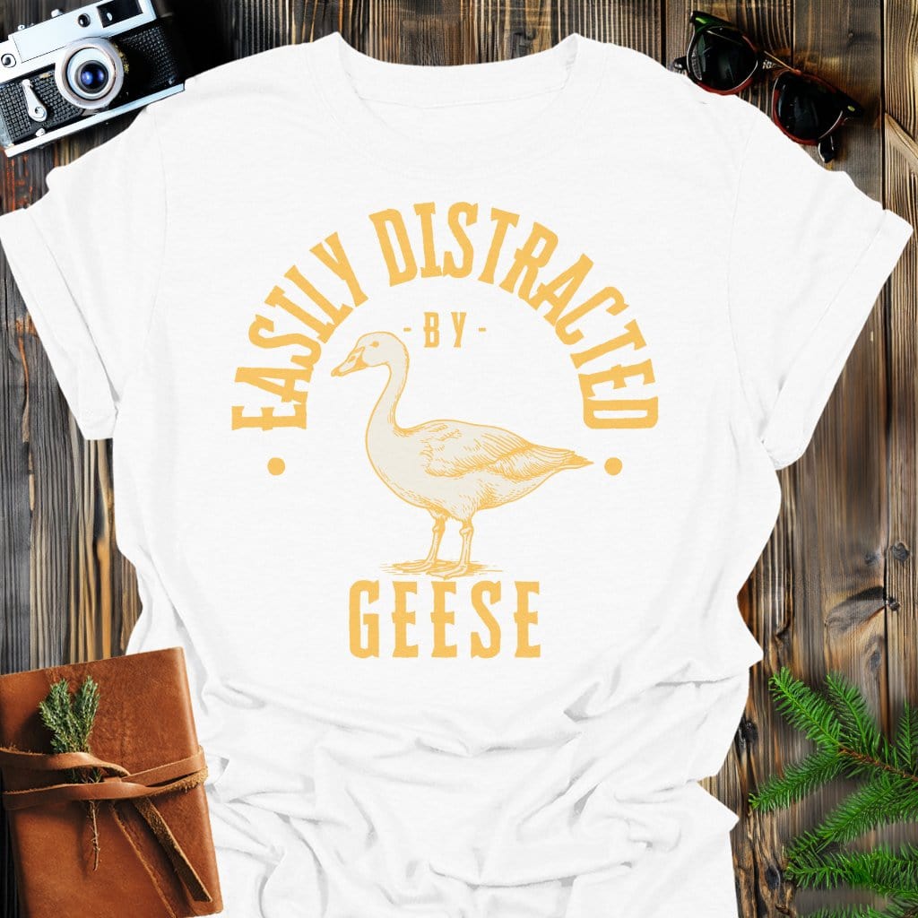 Distracted by Geese T-Shirt In S / White Lightweight adventure tee for outdoor lovers Perfect for hiking camping or road trips Made from soft breathable cotton for all-day comfort Ideal for nature lovers and adventurers FAYO Threads outdoor apparel remember Fun Awaits You Outside