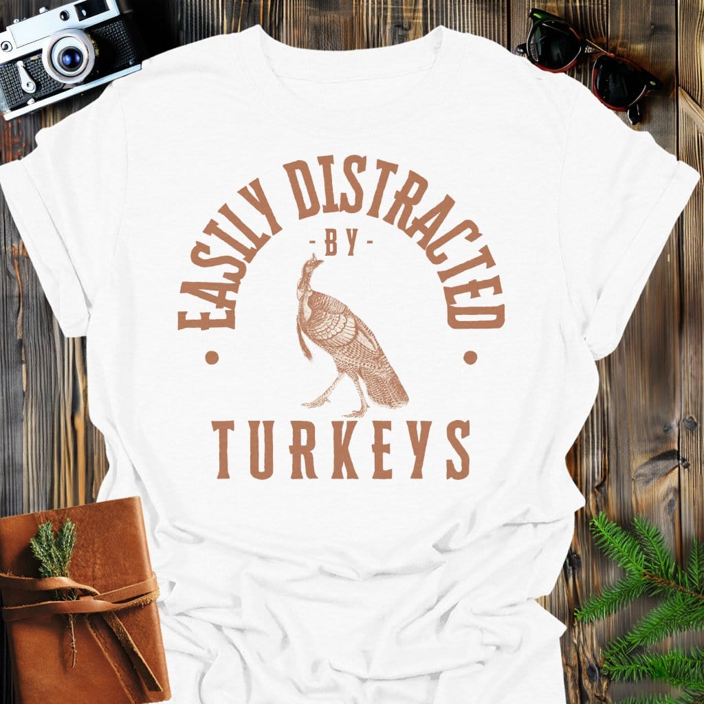 Distracted by Turkeys T-Shirt In S / White Lightweight adventure tee for outdoor lovers Perfect for hiking camping or road trips Made from soft breathable cotton for all-day comfort Ideal for nature lovers and adventurers FAYO Threads outdoor apparel remember Fun Awaits You Outside