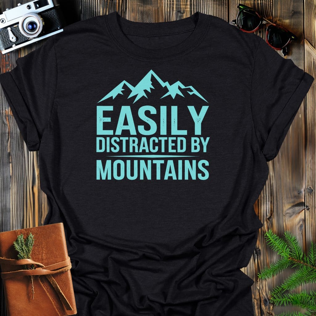 Easily Distracted By Mountains T-Shirt In Black / S Lightweight adventure tee for outdoor lovers Perfect for hiking camping or road trips Made from soft breathable cotton for all-day comfort Ideal for nature lovers and adventurers FAYO Threads outdoor apparel remember Fun Awaits You Outside