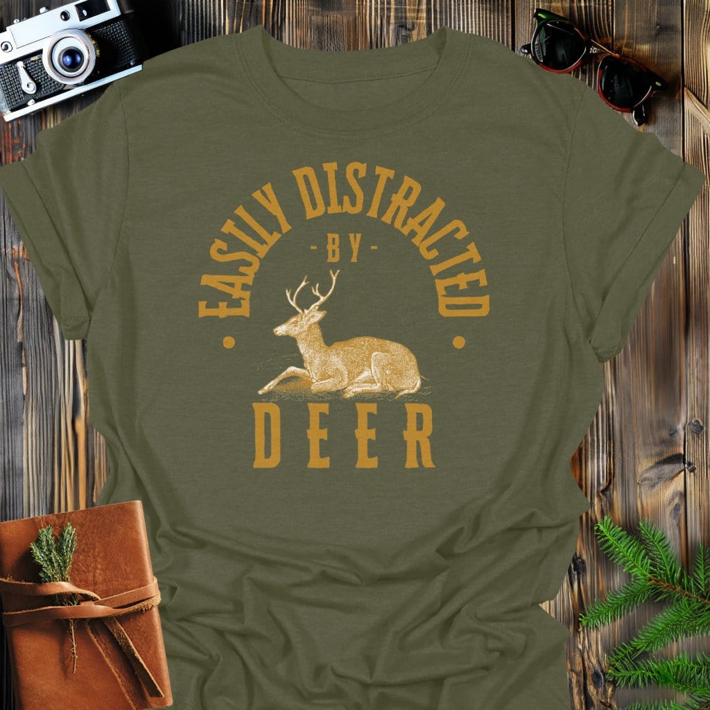 Distracted By Deer T-Shirt In Military Green / S Lightweight adventure tee for outdoor lovers Perfect for hiking camping or road trips Made from soft breathable cotton for all-day comfort Ideal for nature lovers and adventurers FAYO Threads outdoor apparel remember Fun Awaits You Outside