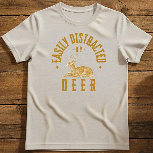 Distracted By Deer T-Shirt In Natural / S Lightweight adventure tee for outdoor lovers Perfect for hiking camping or road trips Made from soft breathable cotton for all-day comfort Ideal for nature lovers and adventurers FAYO Threads outdoor apparel remember Fun Awaits You Outside