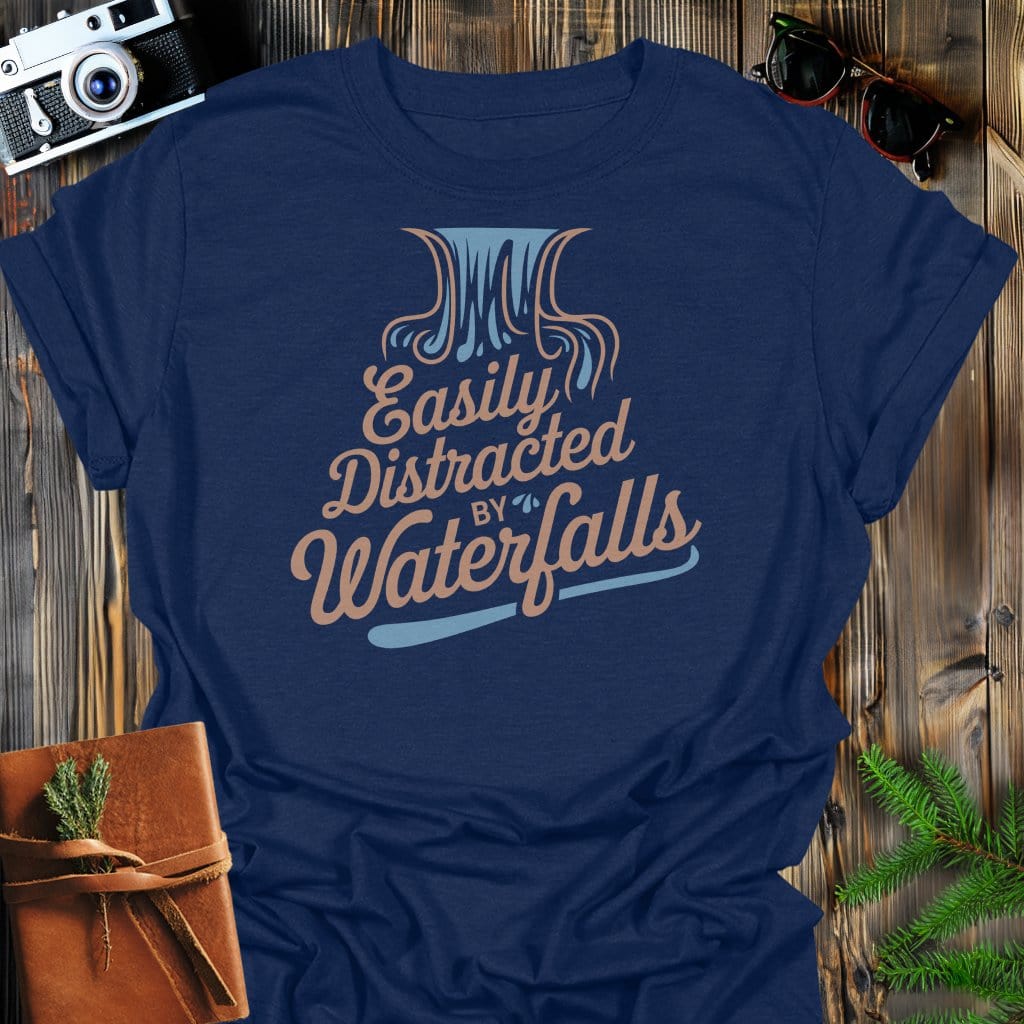 Distracted by Waterfalls T-Shirt In Navy / S Lightweight adventure tee for outdoor lovers Perfect for hiking camping or road trips Made from soft breathable cotton for all-day comfort Ideal for nature lovers and adventurers FAYO Threads outdoor apparel remember Fun Awaits You Outside