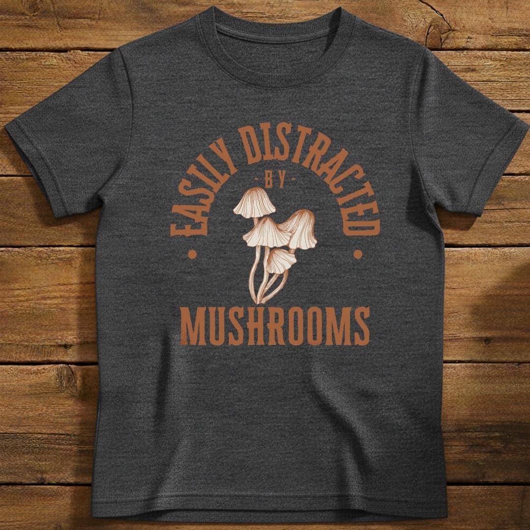 Distracted by Mushrooms T-Shirt In S / Heather Navy Lightweight adventure tee for outdoor lovers Perfect for hiking camping or road trips Made from soft breathable cotton for all-day comfort Ideal for nature lovers and adventurers FAYO Threads outdoor apparel remember Fun Awaits You Outside