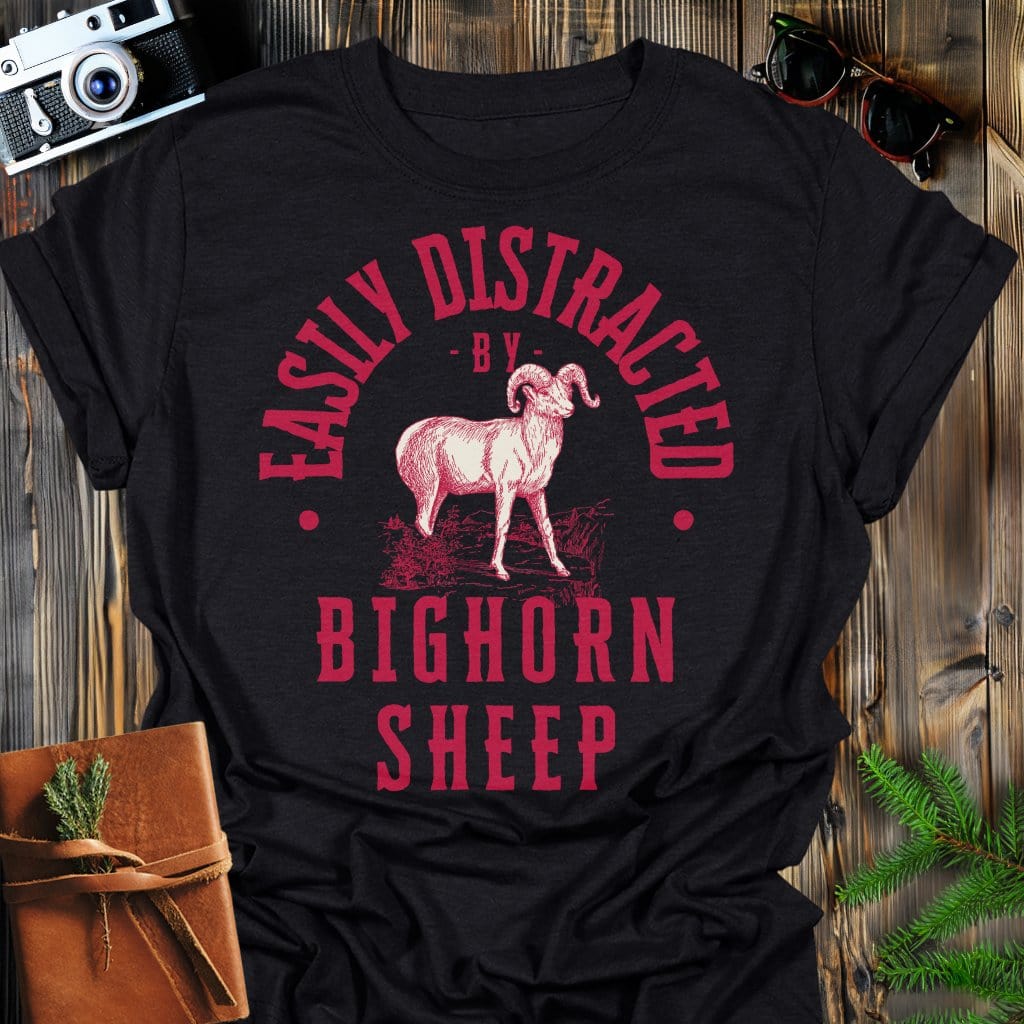 Distracted by Bighorn Sheep T-Shirt In S / Black Lightweight adventure tee for outdoor lovers Perfect for hiking camping or road trips Made from soft breathable cotton for all-day comfort Ideal for nature lovers and adventurers FAYO Threads outdoor apparel remember Fun Awaits You Outside