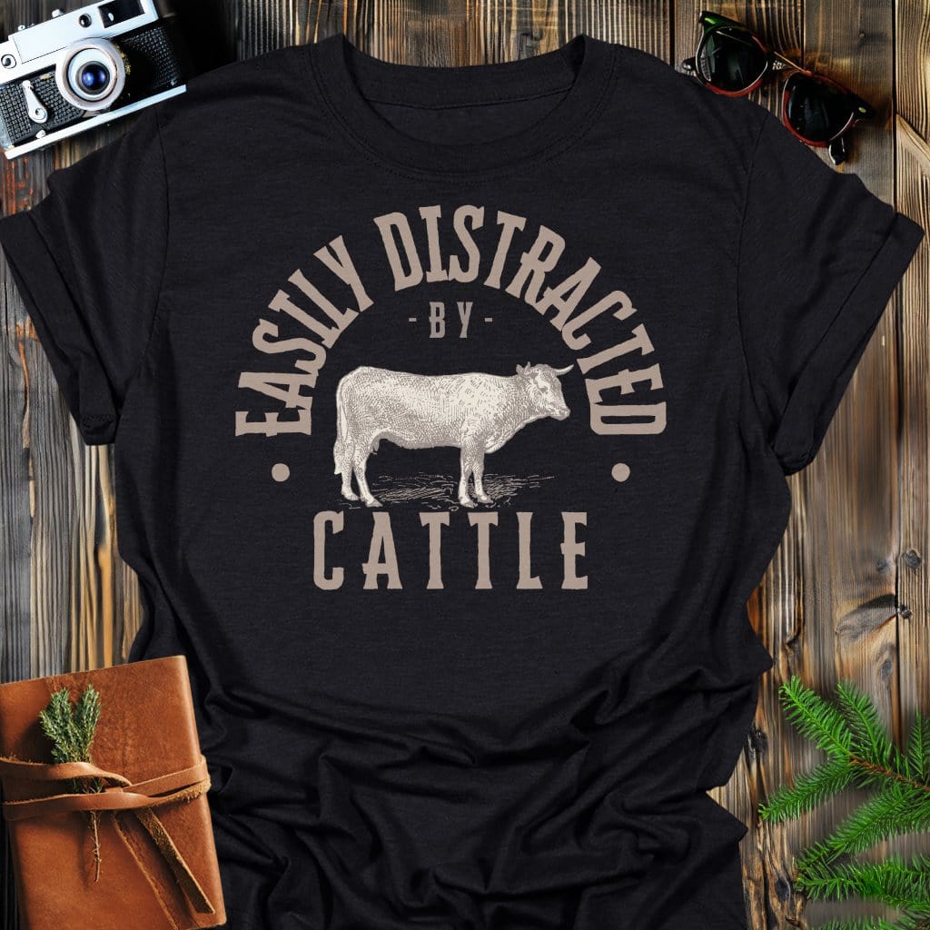 Distracted by Cattle T-Shirt In S / Black Lightweight adventure tee for outdoor lovers Perfect for hiking camping or road trips Made from soft breathable cotton for all-day comfort Ideal for nature lovers and adventurers FAYO Threads outdoor apparel remember Fun Awaits You Outside