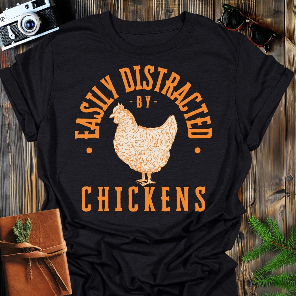 Distracted by Chickens T-Shirt In S / Black Lightweight adventure tee for outdoor lovers Perfect for hiking camping or road trips Made from soft breathable cotton for all-day comfort Ideal for nature lovers and adventurers FAYO Threads outdoor apparel remember Fun Awaits You Outside