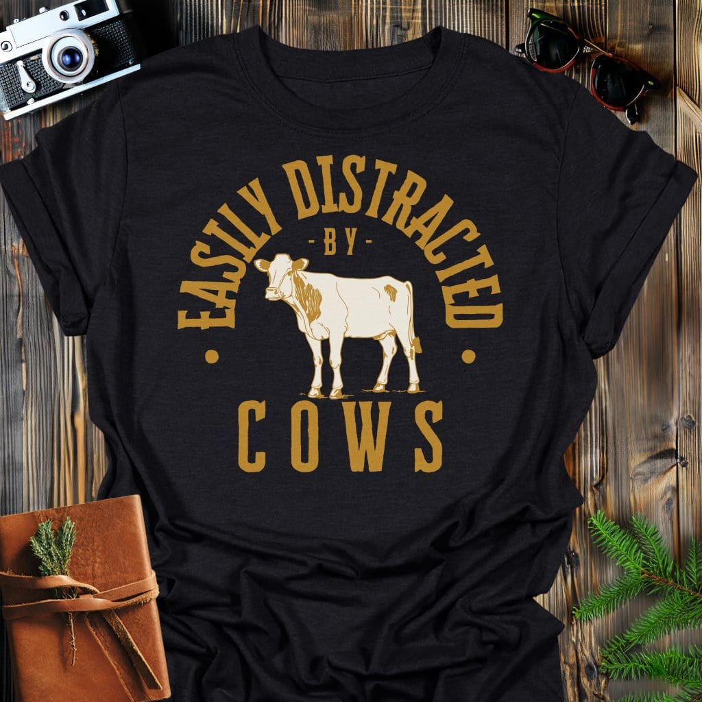 Distracted by Cows T-Shirt In S / Black Lightweight adventure tee for outdoor lovers Perfect for hiking camping or road trips Made from soft breathable cotton for all-day comfort Ideal for nature lovers and adventurers FAYO Threads outdoor apparel remember Fun Awaits You Outside