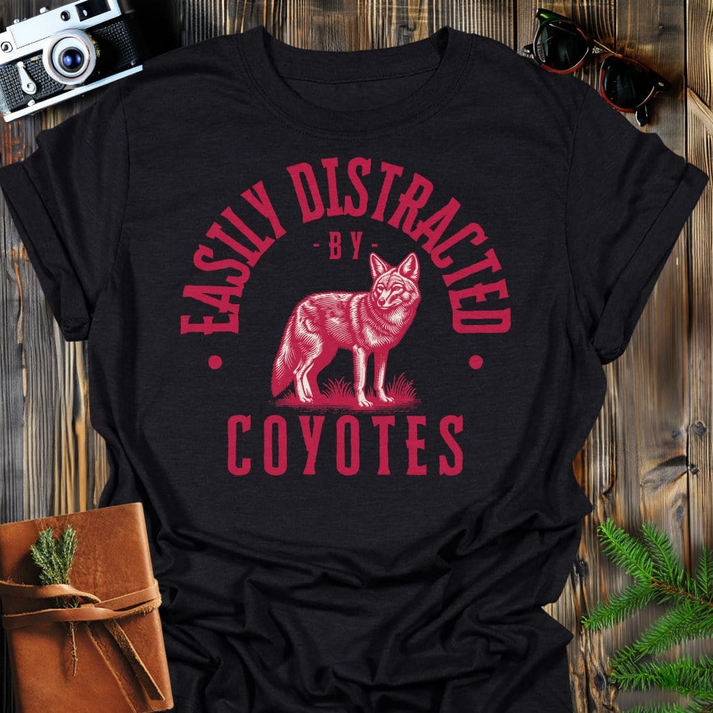 Distracted by Coyotes T-Shirt In S / Black Lightweight adventure tee for outdoor lovers Perfect for hiking camping or road trips Made from soft breathable cotton for all-day comfort Ideal for nature lovers and adventurers FAYO Threads outdoor apparel remember Fun Awaits You Outside