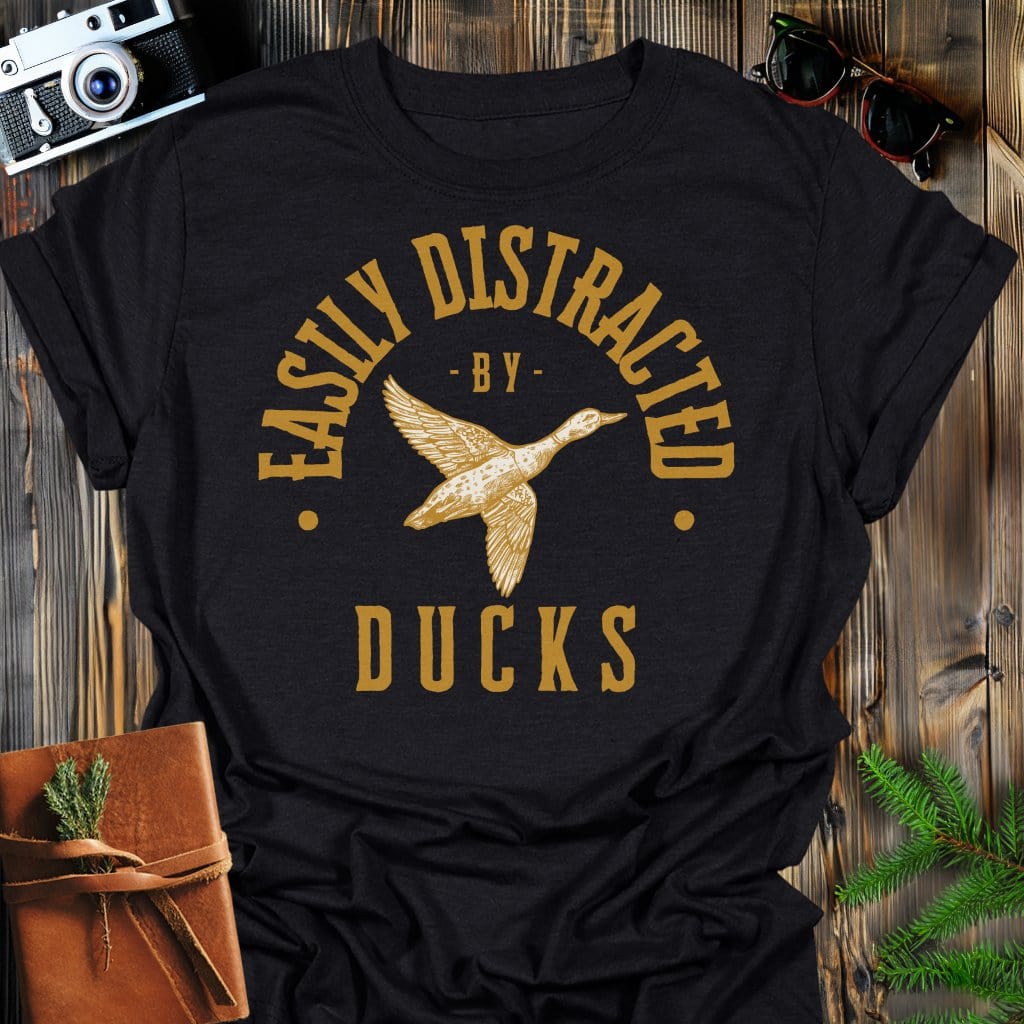 Distracted by Ducks T-Shirt In S / Black Lightweight adventure tee for outdoor lovers Perfect for hiking camping or road trips Made from soft breathable cotton for all-day comfort Ideal for nature lovers and adventurers FAYO Threads outdoor apparel remember Fun Awaits You Outside