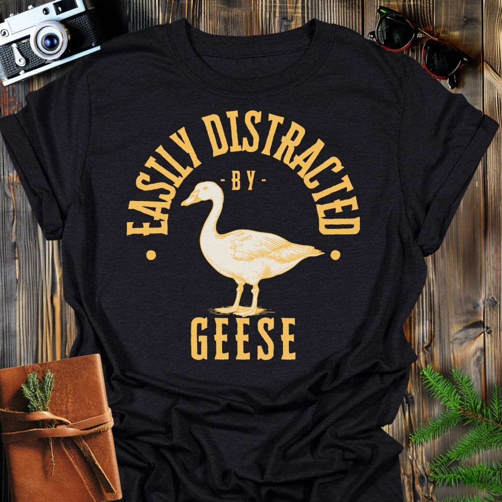 Distracted by Geese T-Shirt In S / Black Lightweight adventure tee for outdoor lovers Perfect for hiking camping or road trips Made from soft breathable cotton for all-day comfort Ideal for nature lovers and adventurers FAYO Threads outdoor apparel remember Fun Awaits You Outside