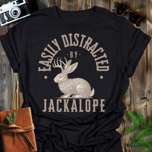 Distracted by Jackalope T-Shirt In S / Black Lightweight adventure tee for outdoor lovers Perfect for hiking camping or road trips Made from soft breathable cotton for all-day comfort Ideal for nature lovers and adventurers FAYO Threads outdoor apparel remember Fun Awaits You Outside